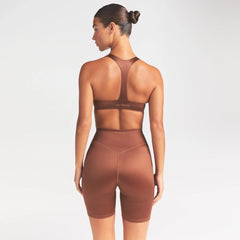 NikeSKIMS SATIN SHINE PLUNGE T-BACK BRA | CAROB BROWN ON A MODEL SIDE VIEW @ | FOCUS: 0.0, 1.0, 0.9