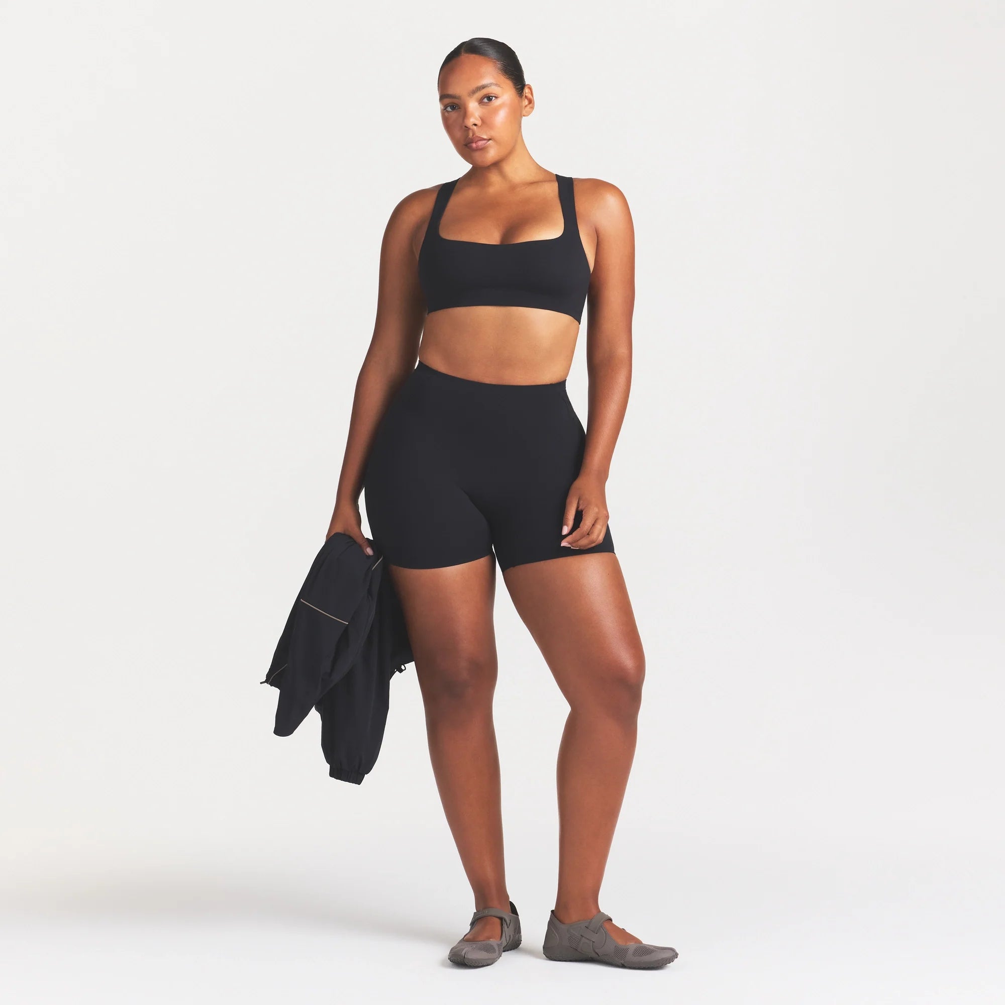 NikeSKIMS STUDIO STRETCH RACERBACK BRA | OBSIDIAN ON A MODEL FRONT VIEW @ | FOCUS: 0.0, 1.0, 0.9