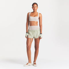 NikeSKIMS ACCESSORIES TRAINING GLOVES | TALC ON A MODEL FRONT VIEW @ | FOCUS: 0.0, 1.0, 0.9
