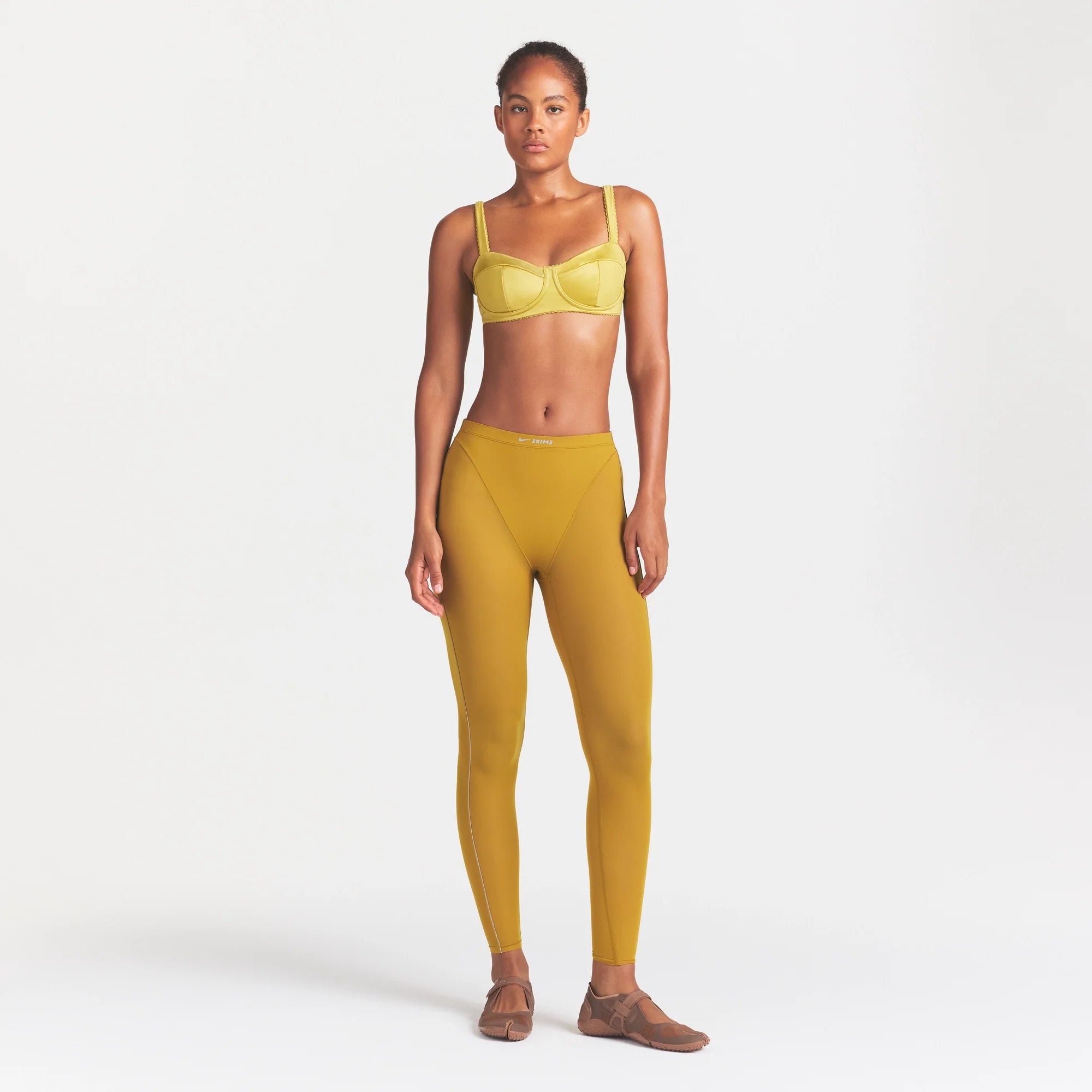NikeSKIMS SATIN SHINE PANELED PICOT BRA | CITRINE ON A MODEL FRONT VIEW @ | FOCUS: 0.0, 1.0, 0.9