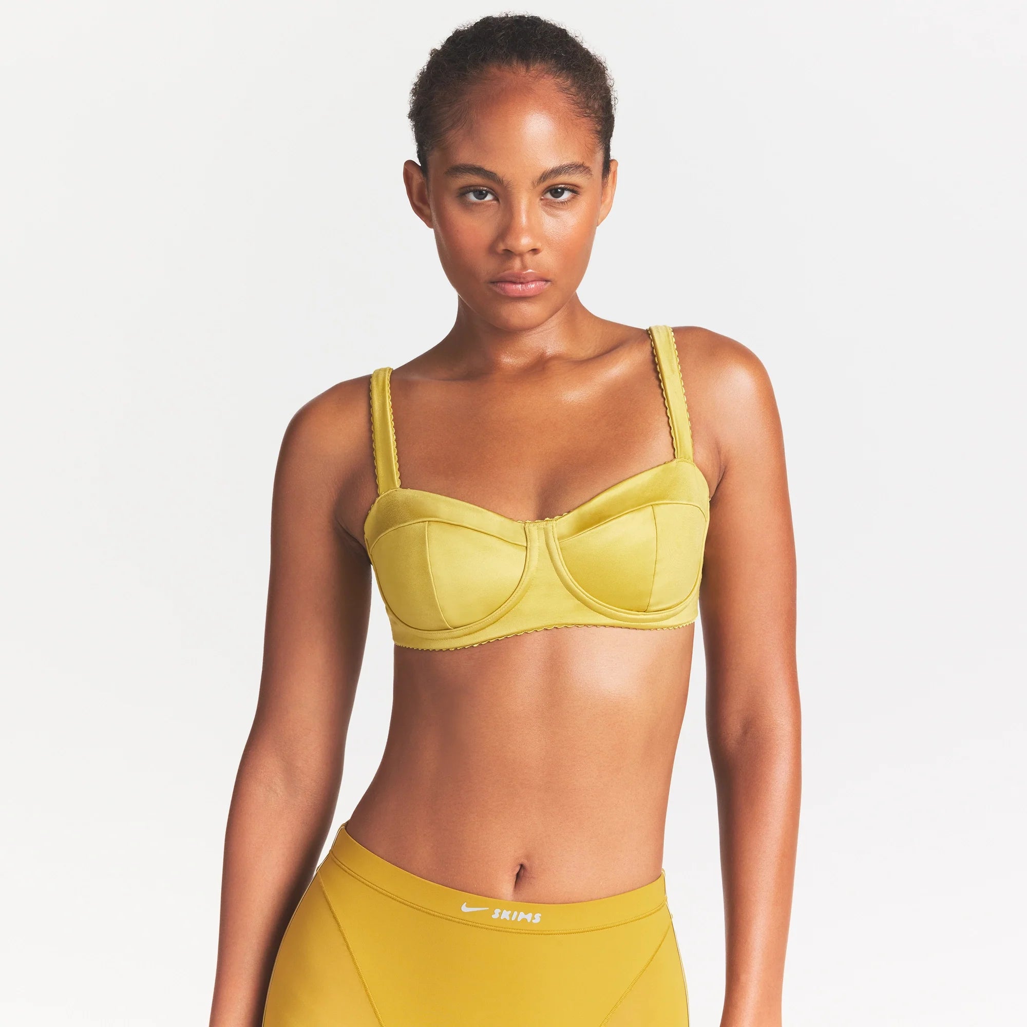 NikeSKIMS SATIN SHINE PANELED PICOT BRA | CITRINE ON A MODEL SIDE VIEW @ | FOCUS: 0.0, 1.0, 0.9
