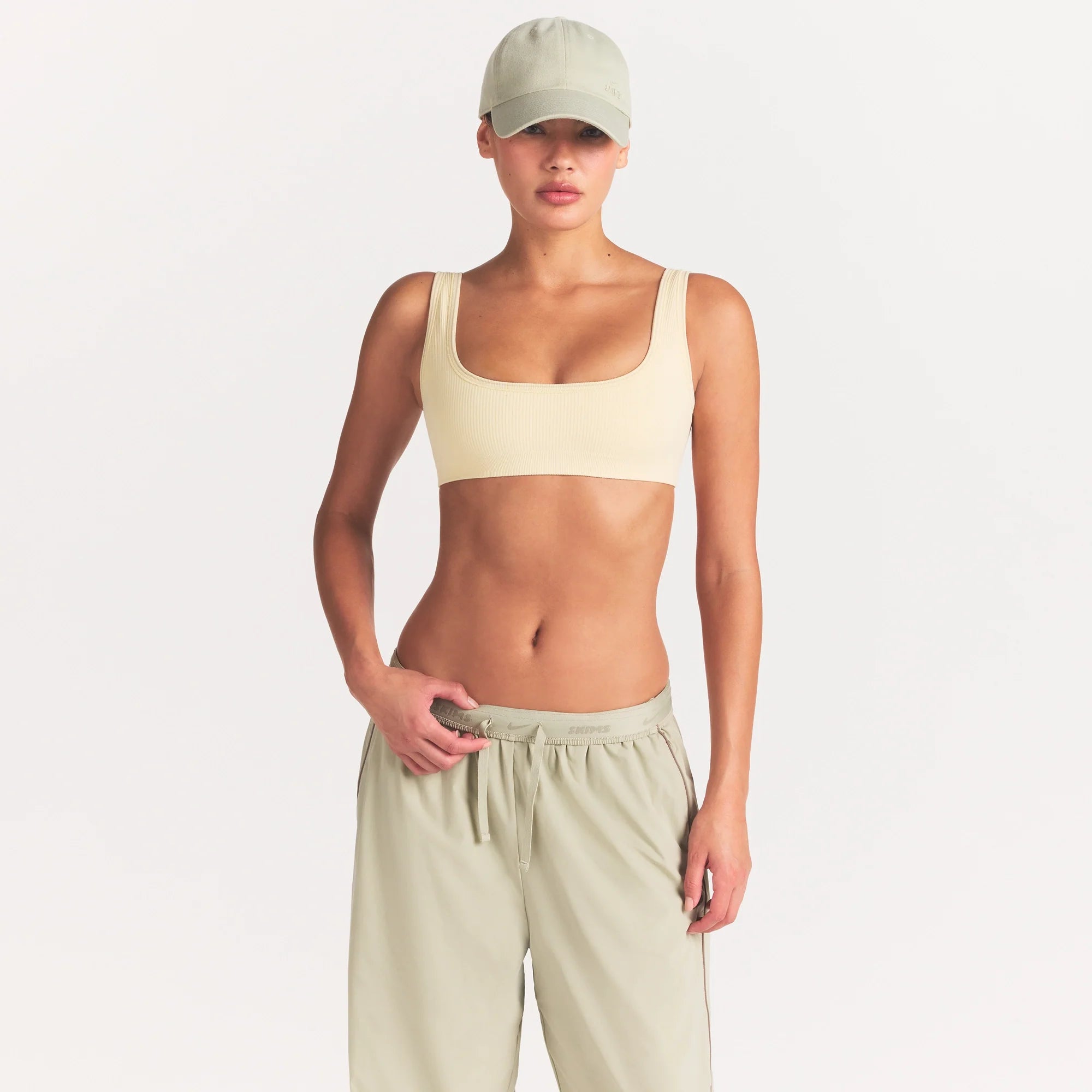 NikeSKIMS RIBBED SEAMLESS MICRO SCOOP BRA | LEMON DROP ON A MODEL FRONT VIEW @ | FOCUS: 0.0, 1.0, 0.9