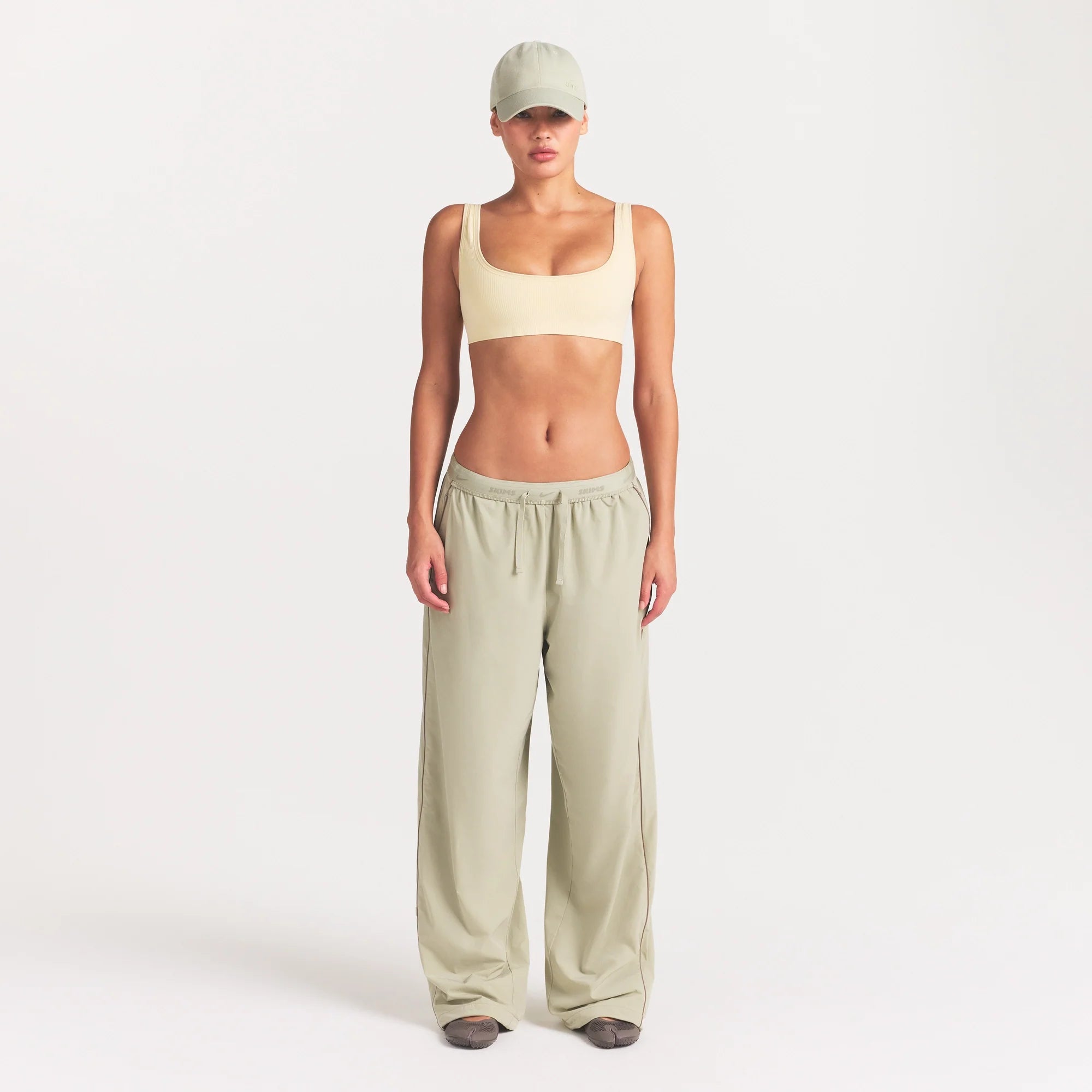 NikeSKIMS RIBBED SEAMLESS MICRO SCOOP BRA | LEMON DROP ON A MODEL FRONT VIEW @ | FOCUS: 0.0, 1.0, 0.9