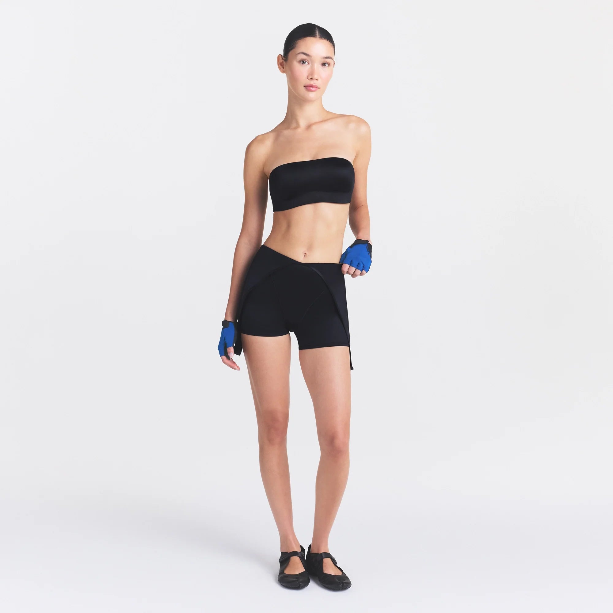 NikeSKIMS SATIN SHINE SUSPENDER 2.5" ONESIE | OBSIDIAN ON A MODEL FRONT VIEW