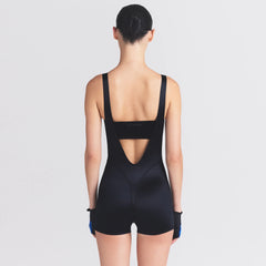 NikeSKIMS SATIN SHINE SUSPENDER 2.5" ONESIE | OBSIDIAN ON A MODEL SIDE VIEW