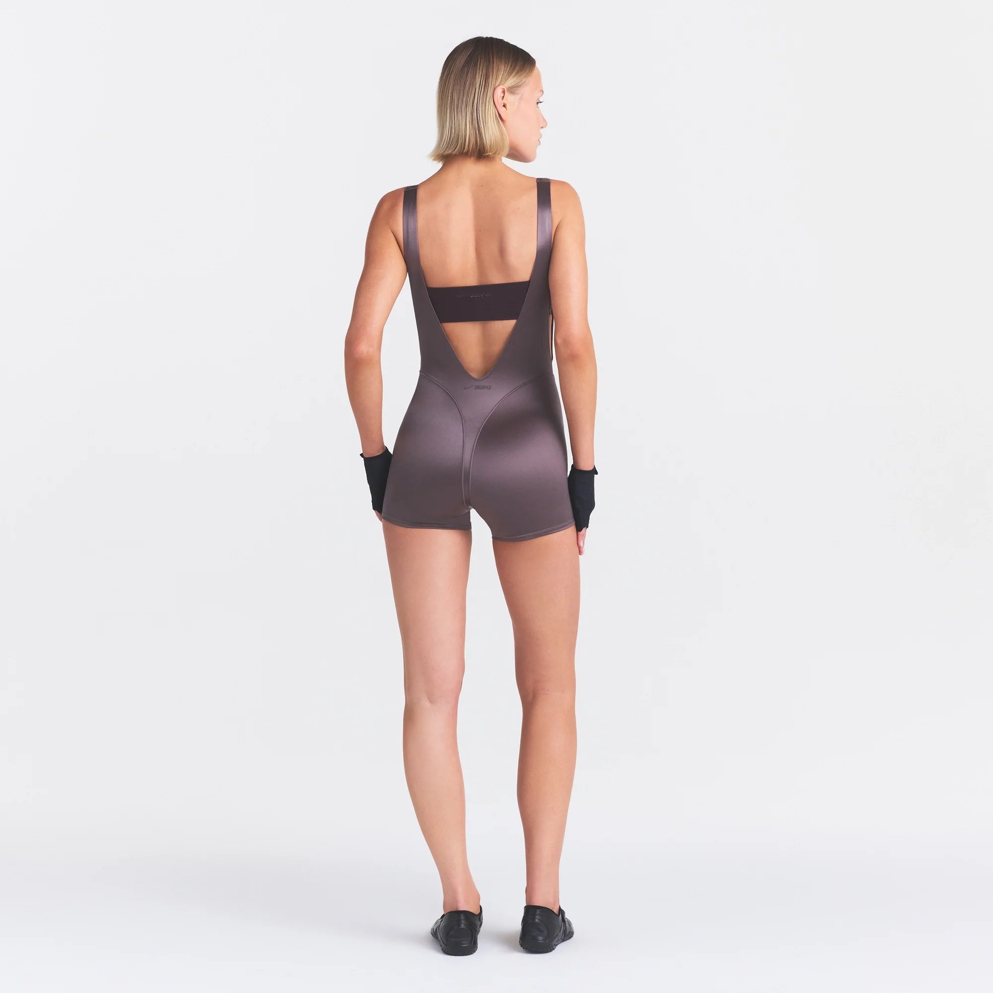 NikeSKIMS SATIN SHINE SUSPENDER 2.5" ONESIE | RESIN ON A MODEL FRONT VIEW