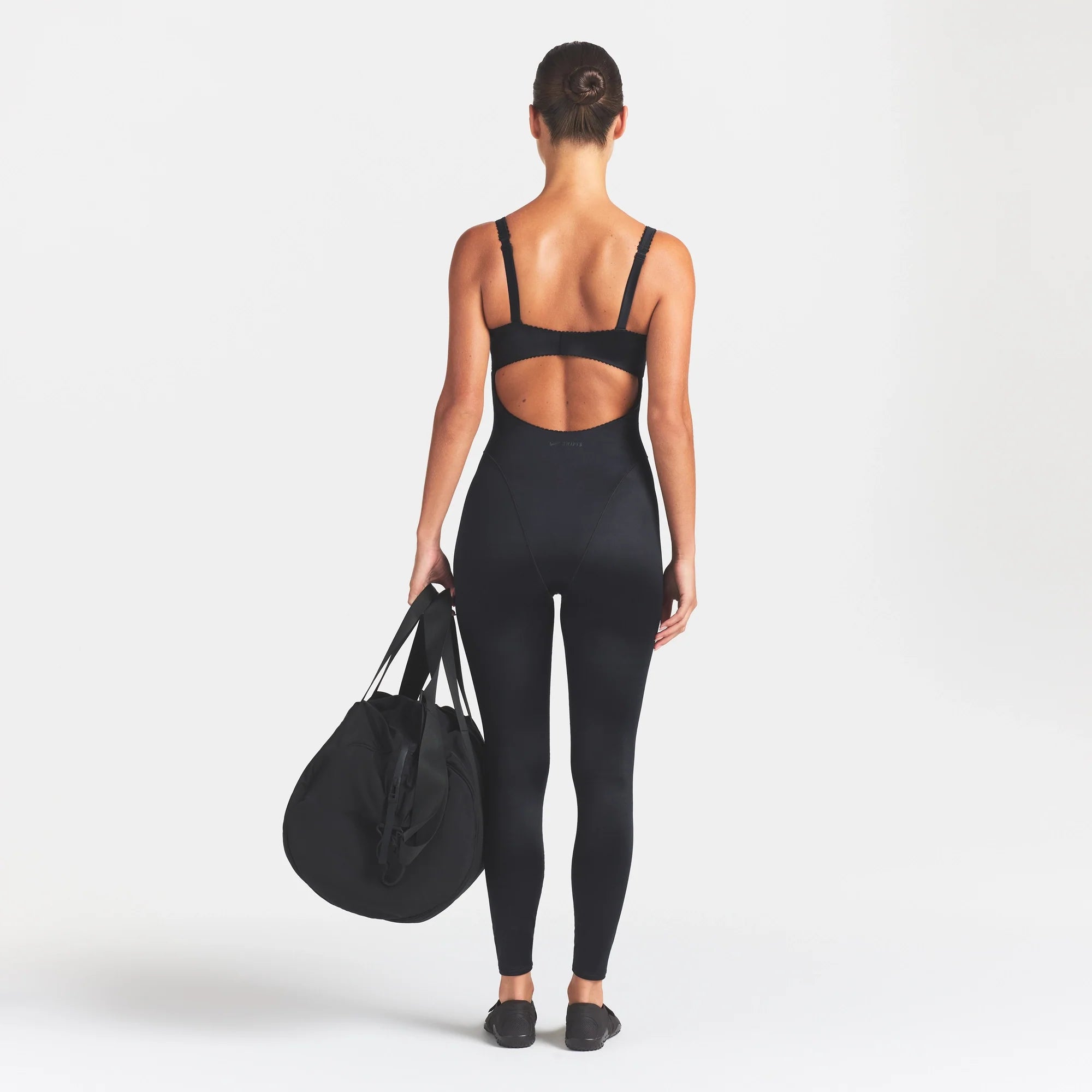 NikeSKIMS SATIN SHINE PANELED 26" ONE PIECE | OBSIDIAN ON A MODEL FRONT VIEW