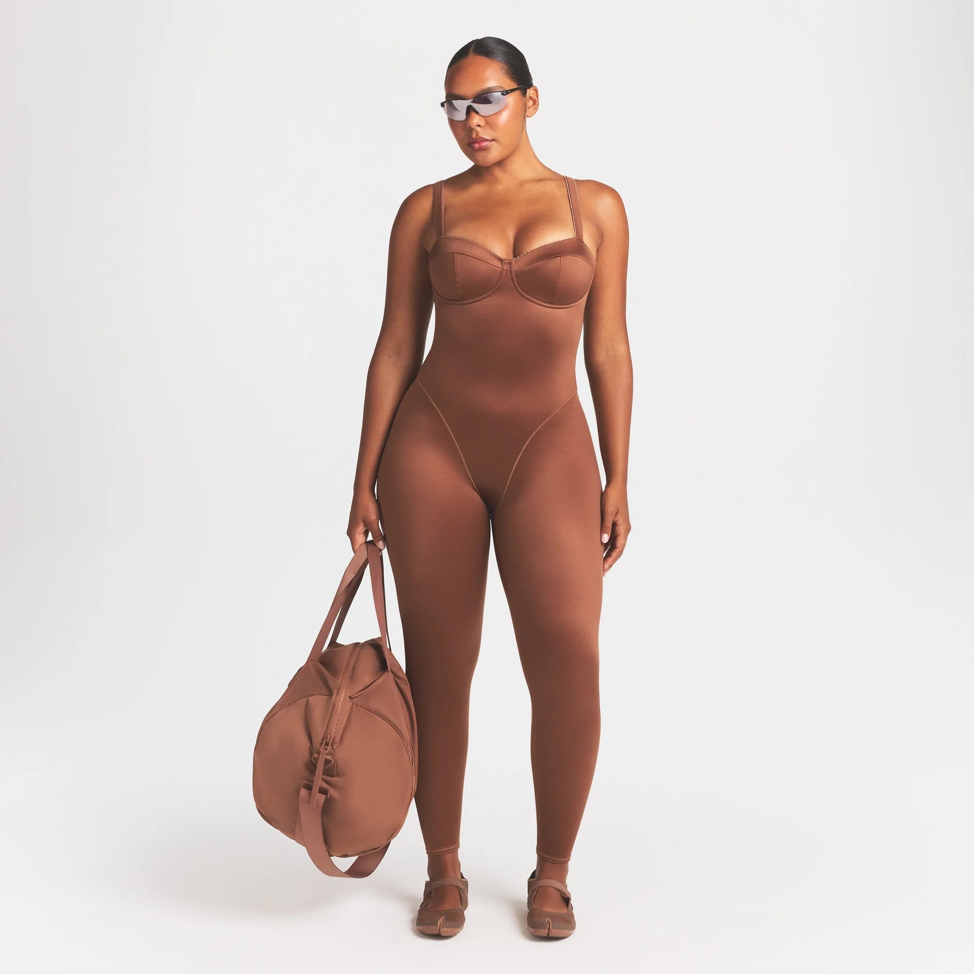 NikeSKIMS SATIN SHINE PANELED 26" ONE PIECE | CAROB BROWN ON A MODEL FRONT VIEW @ | FOCUS: 0.0, 1.0, 0.9