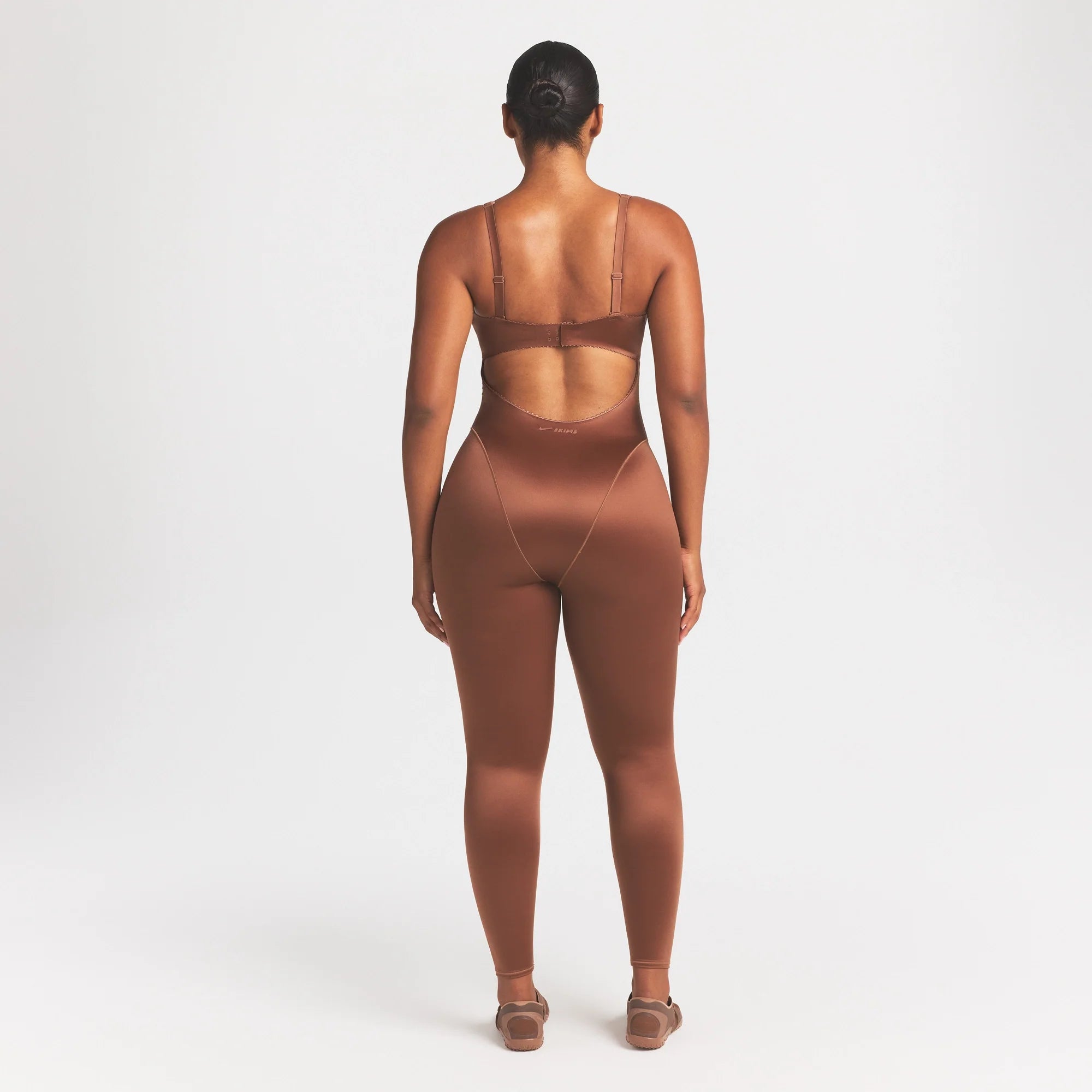 NikeSKIMS SATIN SHINE PANELED 26" ONE PIECE | CAROB BROWN ON A MODEL FRONT VIEW @ | FOCUS: 0.0, 1.0, 0.9