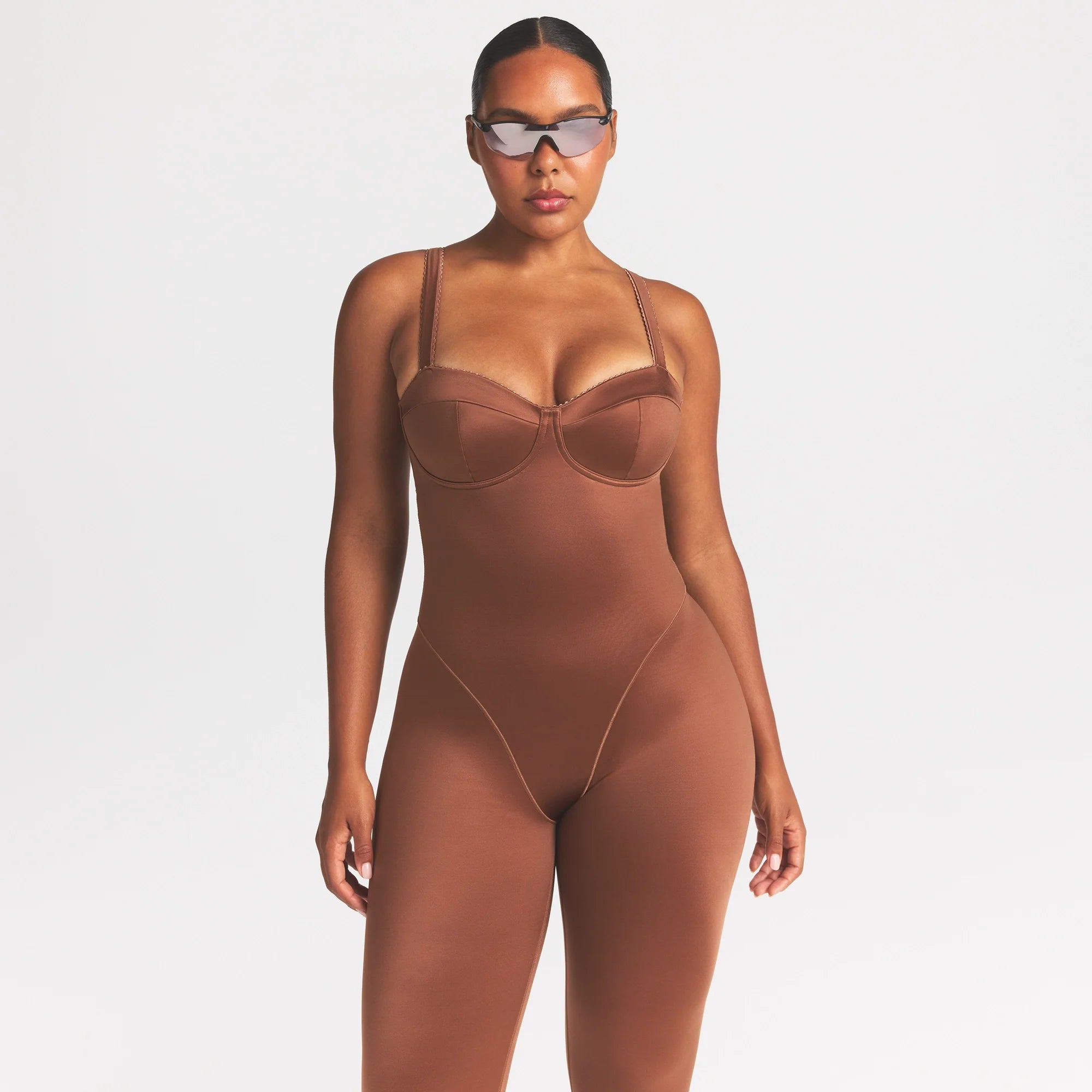 NikeSKIMS SATIN SHINE PANELED 26" ONE PIECE | CAROB BROWN ON A MODEL SIDE VIEW @ | FOCUS: 0.0, 1.0, 0.9