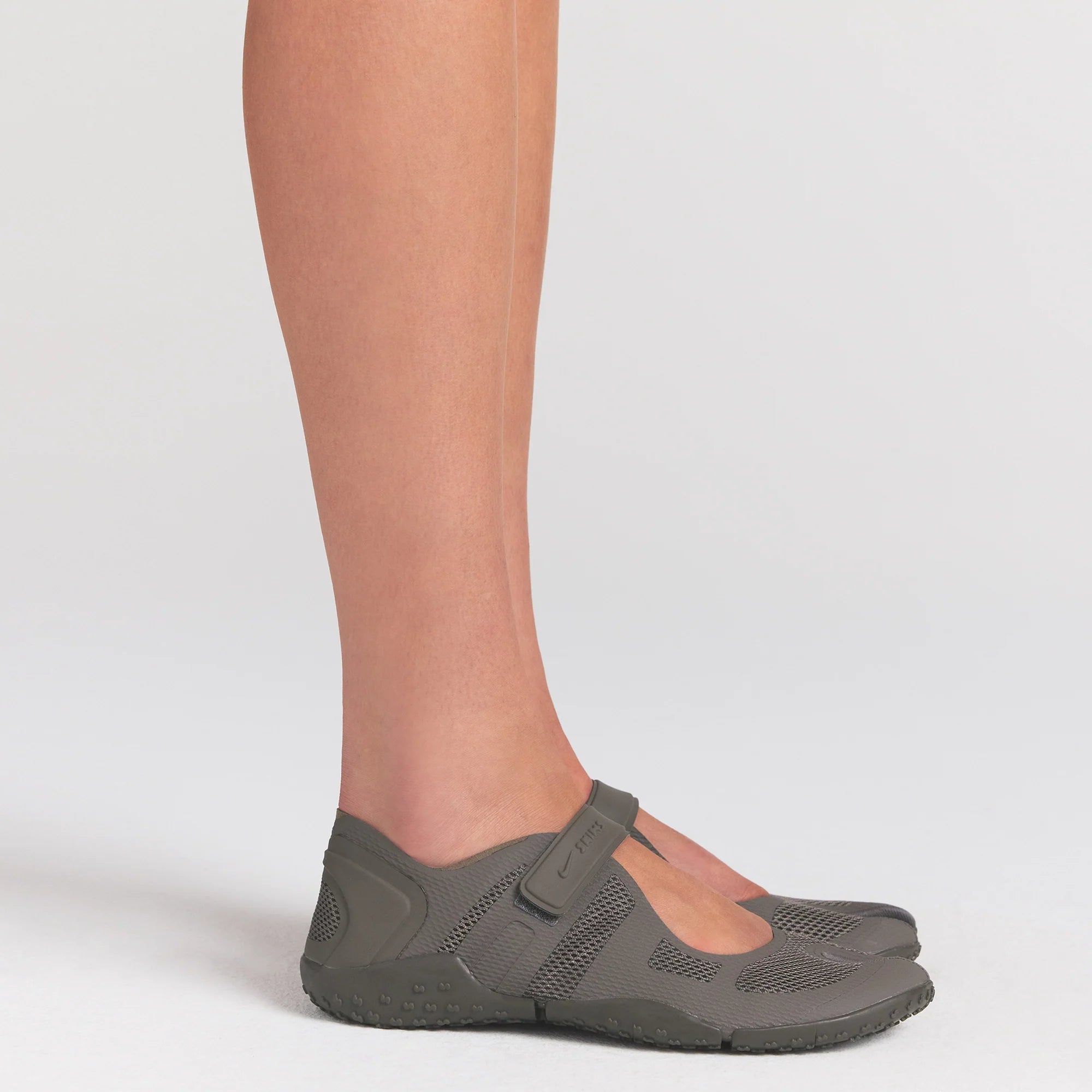 NikeSKIMS FOOTWEAR RIFT MESH | CAVE STONE/CAVE STONE-MED ASH ON A MODEL SIDE VIEW @ | FOCUS: 0.0, 1.0, 0.9