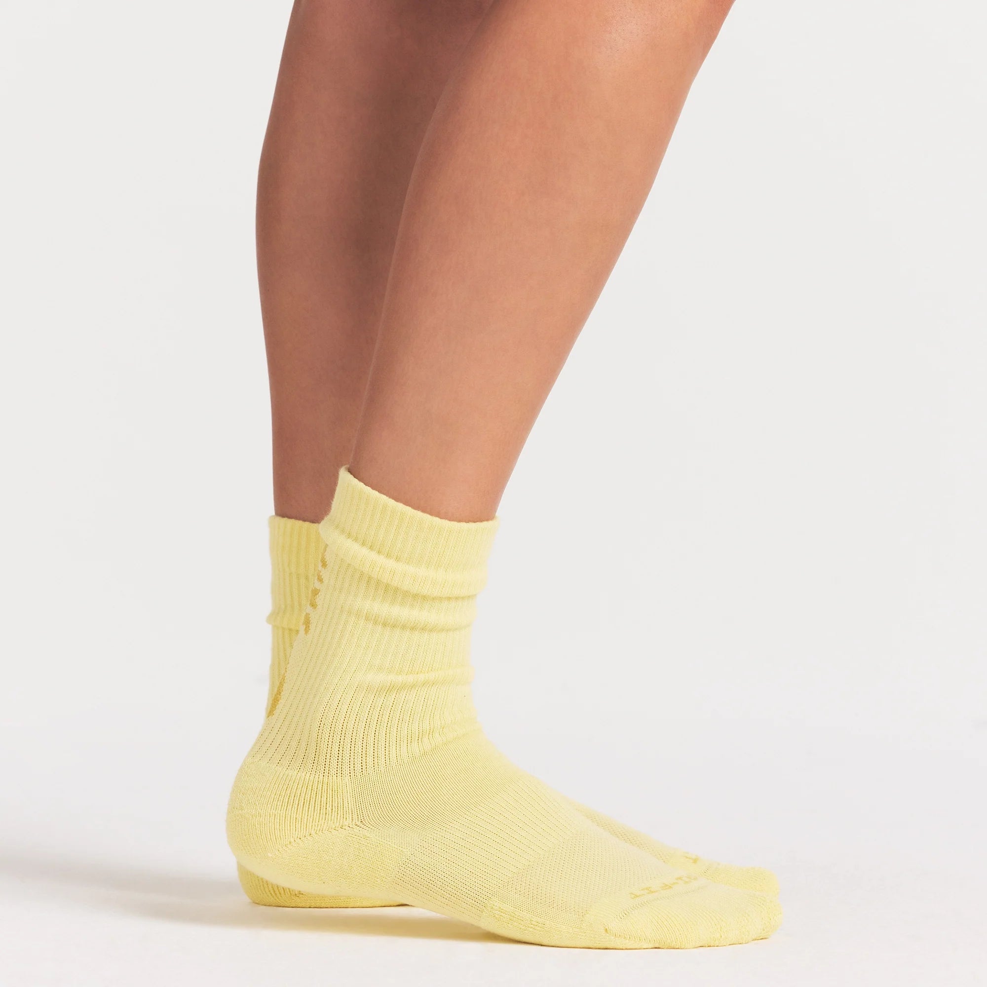 NikeSKIMS ACCESSORIES DRI-FIT™ CREW SOCK 3-PACK | DRIFTWOOD/TALC/BICYCLE YELLOW ON A MODEL SIDE VIEW