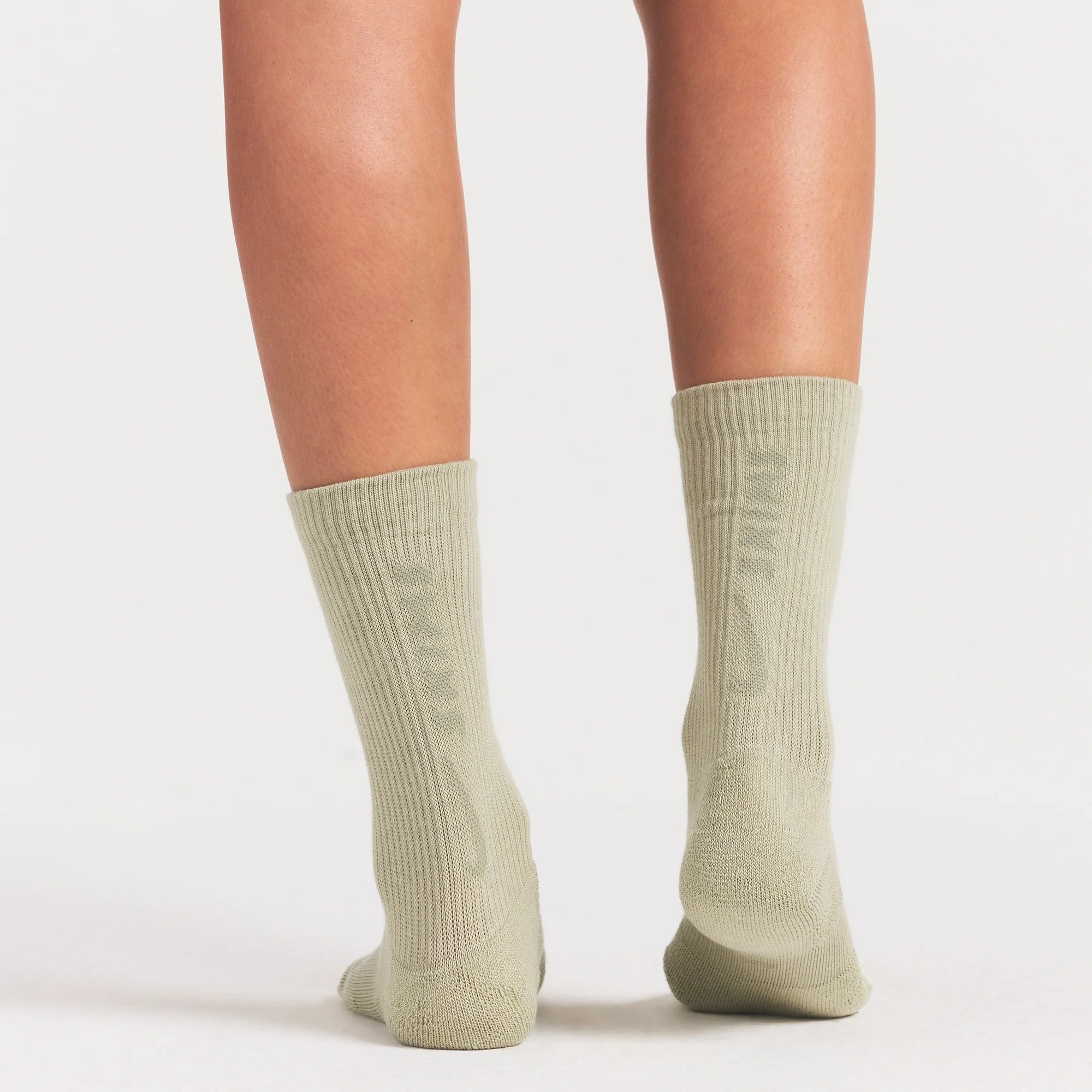 NikeSKIMS ACCESSORIES DRI-FIT™ CREW SOCK 3-PACK | DRIFTWOOD/TALC/BICYCLE YELLOW ON A MODEL SIDE VIEW