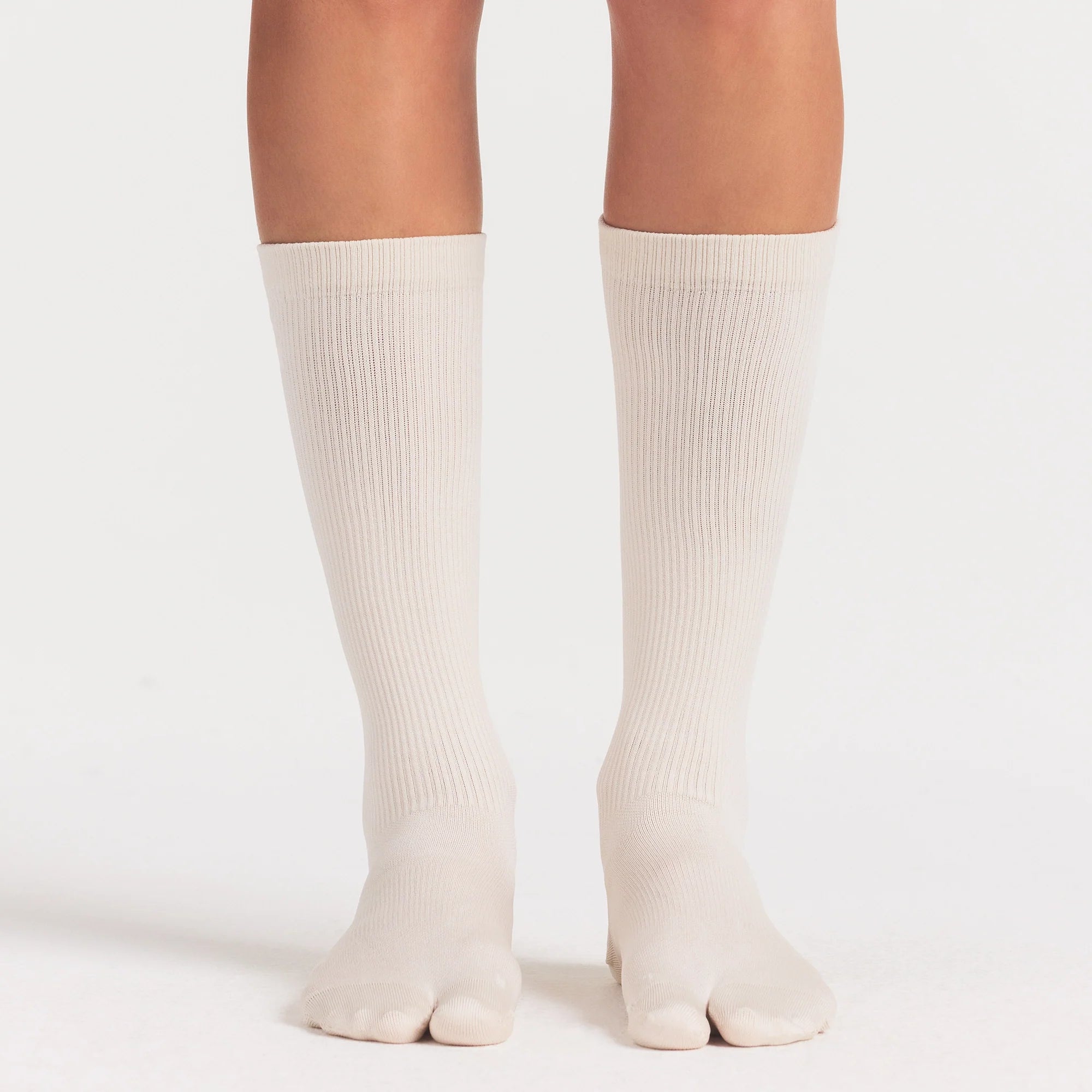 NikeSKIMS ACCESSORIES RIFT KNEE HIGH SOCK | LIGHT OREWOOD BROWN ON A MODEL SIDE VIEW @ | FOCUS: 0.0, 1.0, 0.9