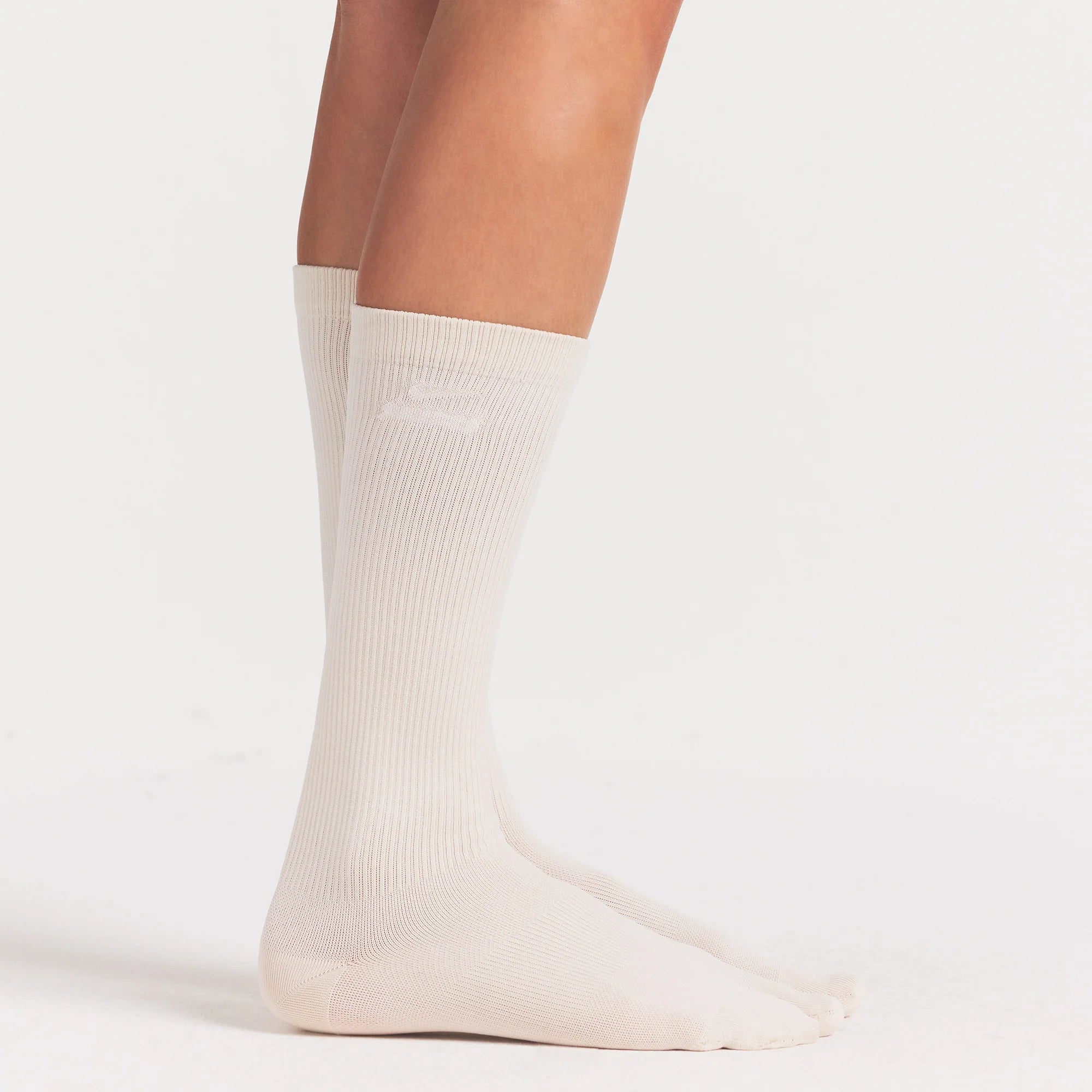 NikeSKIMS ACCESSORIES RIFT KNEE HIGH SOCK | LIGHT OREWOOD BROWN ON A MODEL SIDE VIEW @ | FOCUS: 0.0, 1.0, 0.9