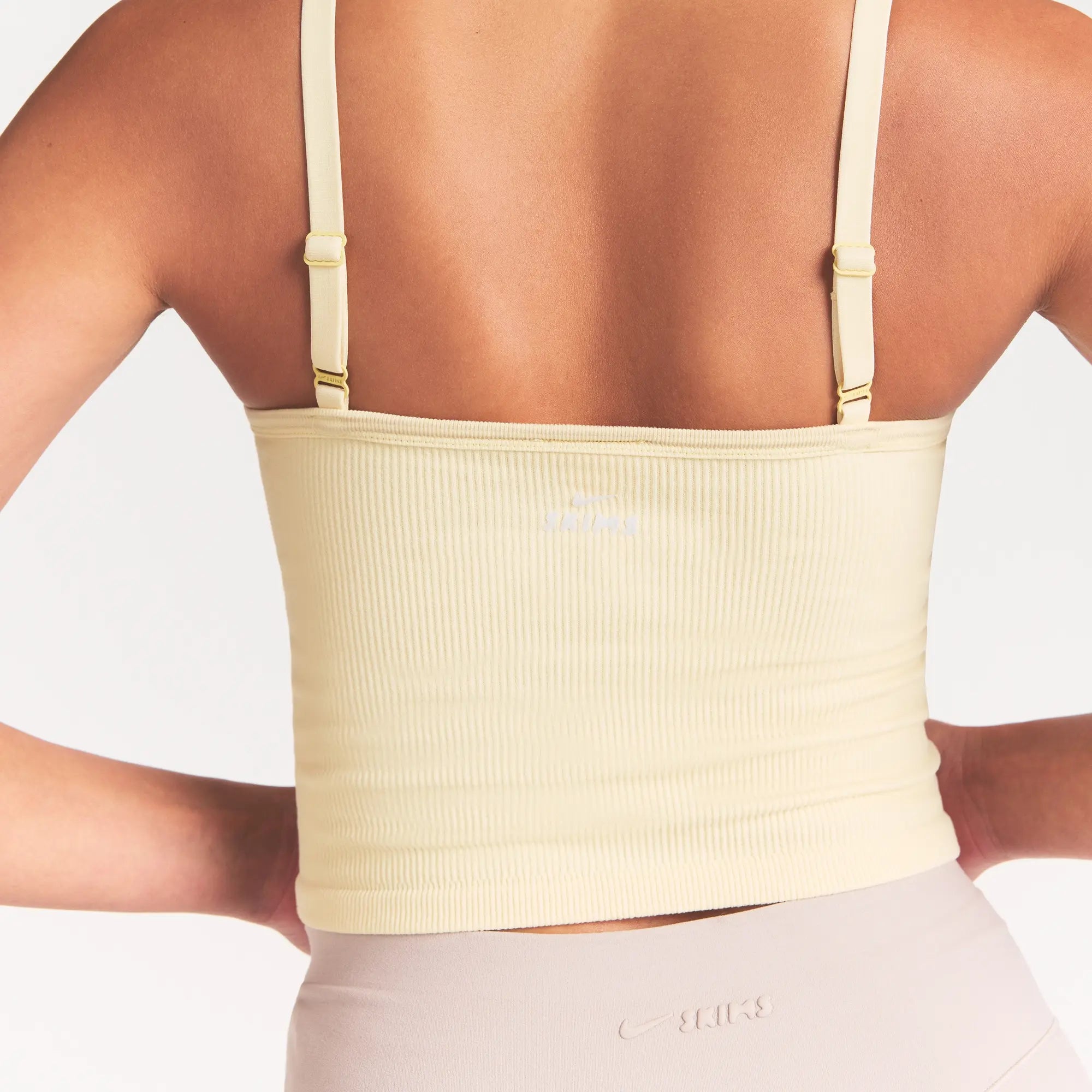 NikeSKIMS RIBBED SEAMLESS CAMI | LEMON DROP ON A MODEL SIDE VIEW @ | FOCUS: 0.0, 1.0, 0.9