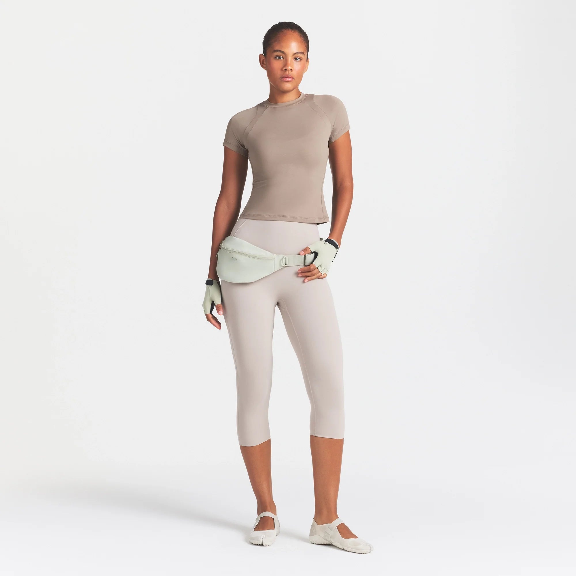 NikeSKIMS AIRY DRI-FIT BABY T-SHIRT | DRIFTWOOD ON A MODEL FRONT VIEW @ | FOCUS: 0.0, 1.0, 0.9