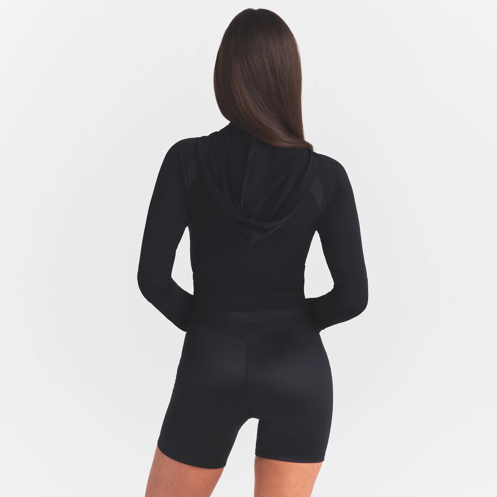 NikeSKIMS STRETCH KNIT SHRUNKEN ZIP HOODIE | OBSIDIAN ON A MODEL SIDE VIEW @ | FOCUS: 0.0, 1.0, 0.9