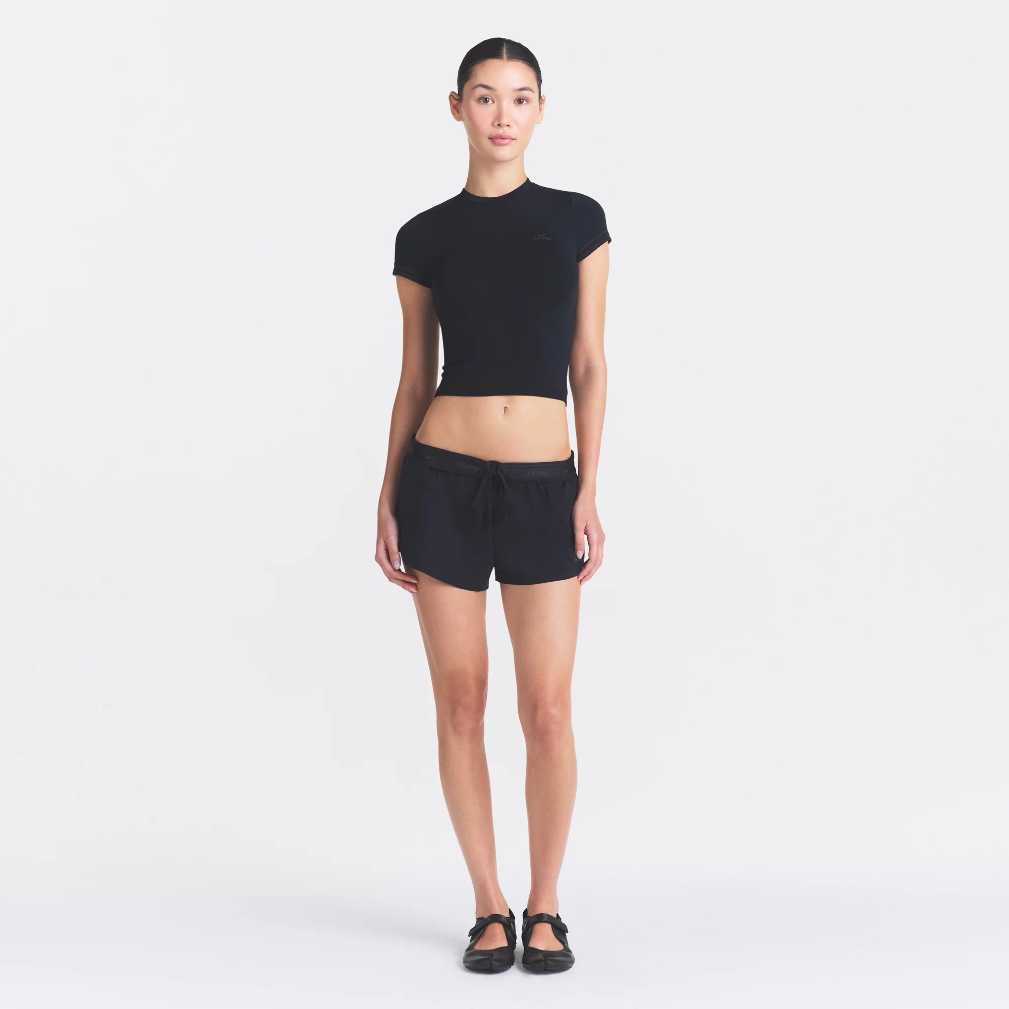 NikeSKIMS STRETCH KNIT CROPPED T-SHIRT | OBSIDIAN ON A MODEL FRONT VIEW @ | FOCUS: 0.0, 1.0, 0.9