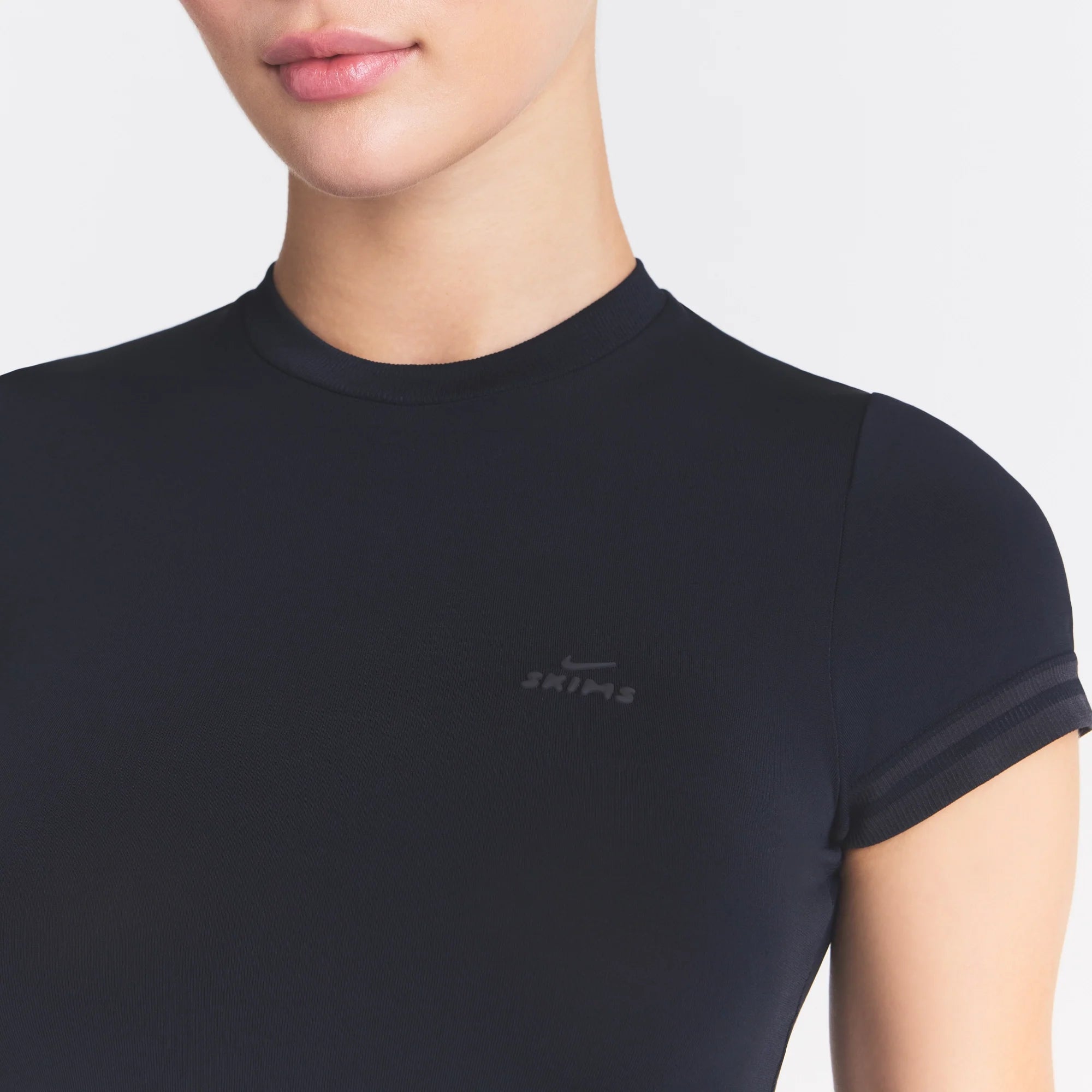 NikeSKIMS STRETCH KNIT CROPPED T-SHIRT | OBSIDIAN ON A MODEL SIDE VIEW @ | FOCUS: 0.0, 1.0, 0.9