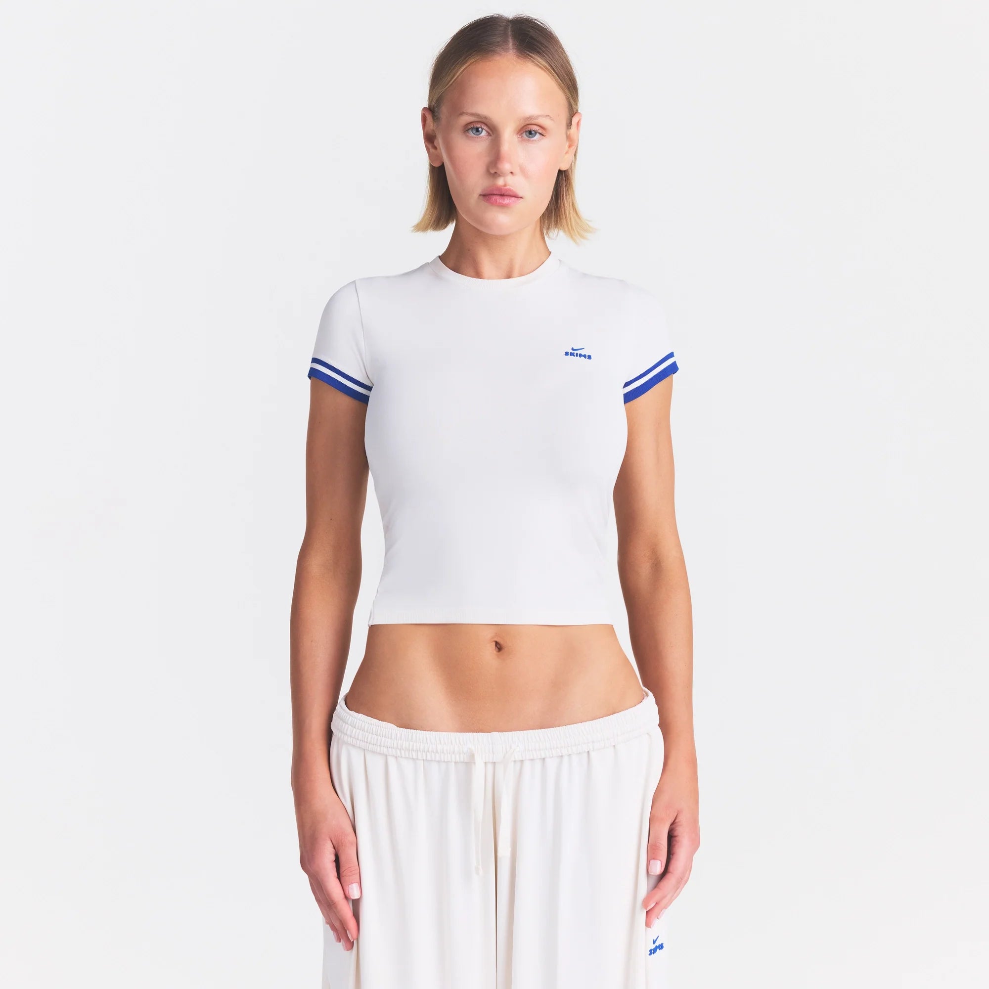 NikeSKIMS STRETCH KNIT CROPPED T-SHIRT | IVORY ON A MODEL SIDE VIEW @ | FOCUS: 0.0, 1.0, 0.9