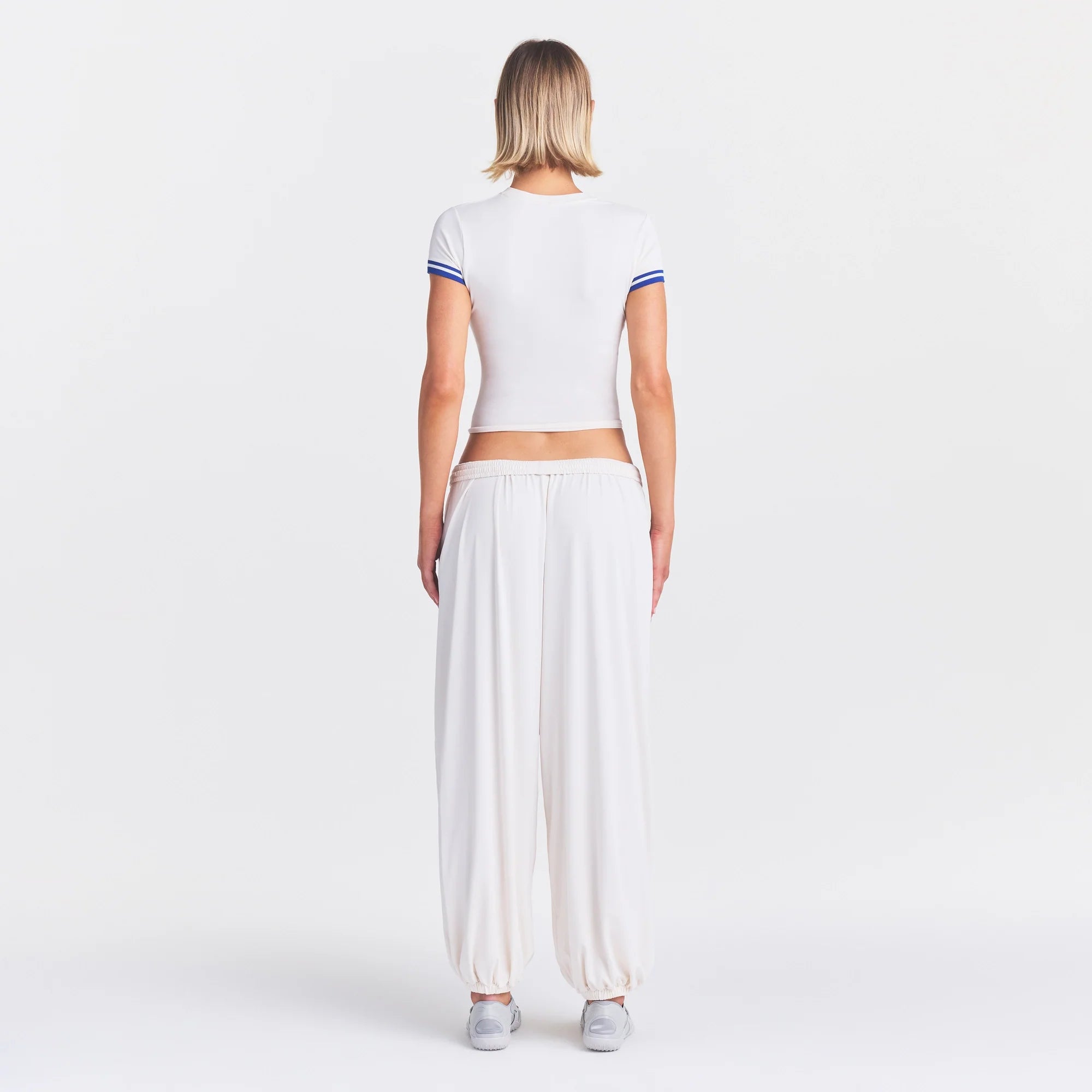 NikeSKIMS STRETCH KNIT CROPPED T-SHIRT | IVORY ON A MODEL FRONT VIEW @ | FOCUS: 0.0, 1.0, 0.9