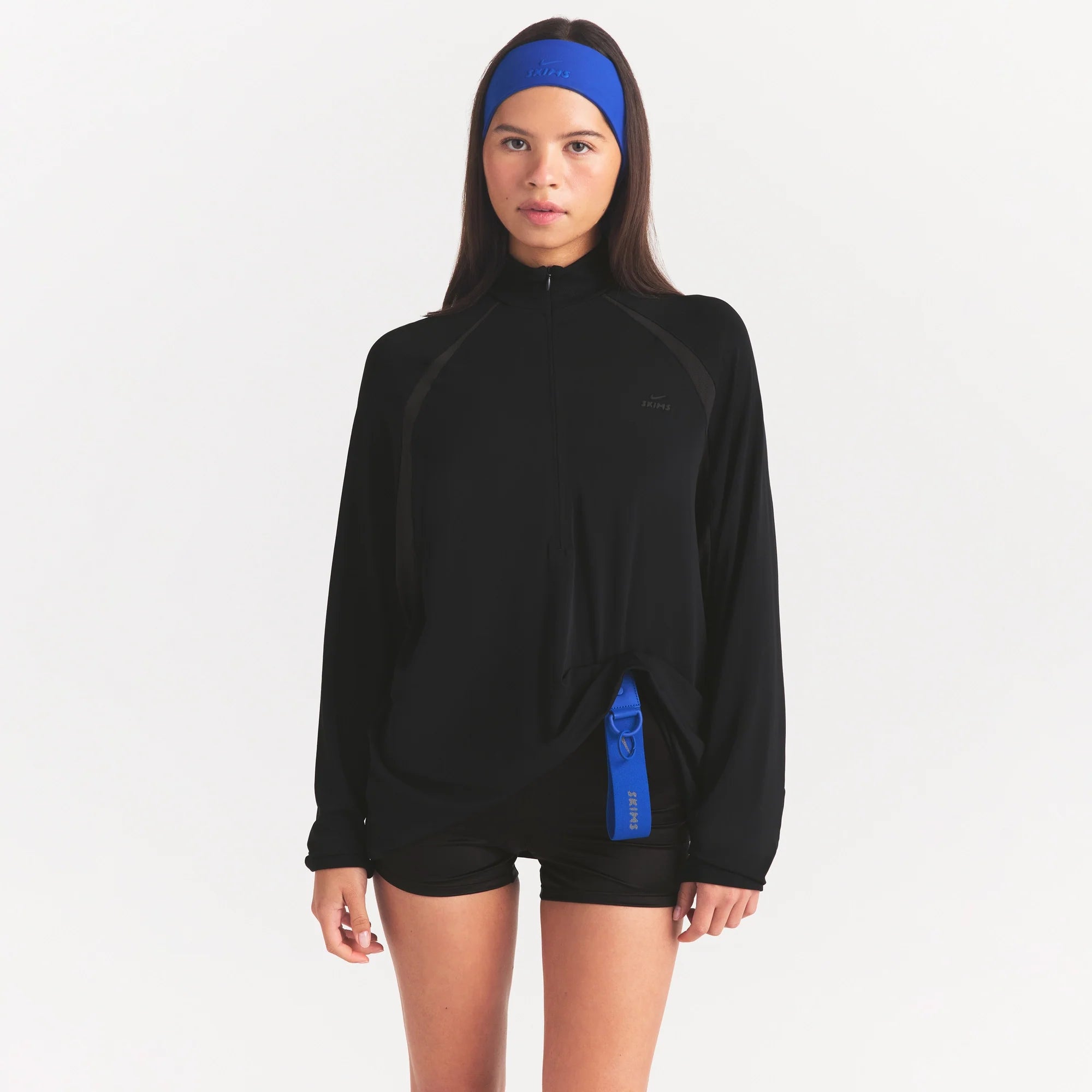 NikeSKIMS STRETCH KNIT LONG SLEEVE HALF ZIP | OBSIDIAN ON A MODEL SIDE VIEW @ | FOCUS: 0.0, 1.0, 0.9