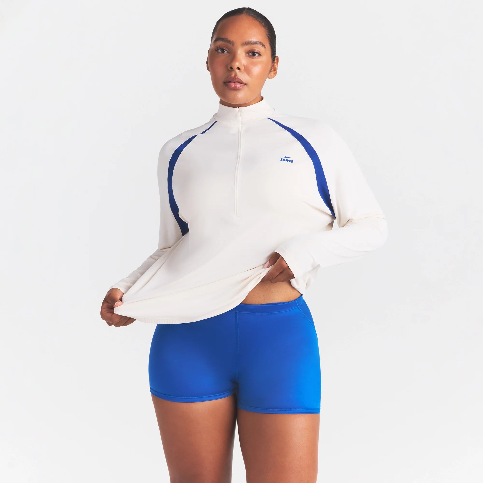 NikeSKIMS STRETCH KNIT LONG SLEEVE HALF ZIP | IVORY ON A MODEL SIDE VIEW @ | FOCUS: 0.0, 1.0, 0.9