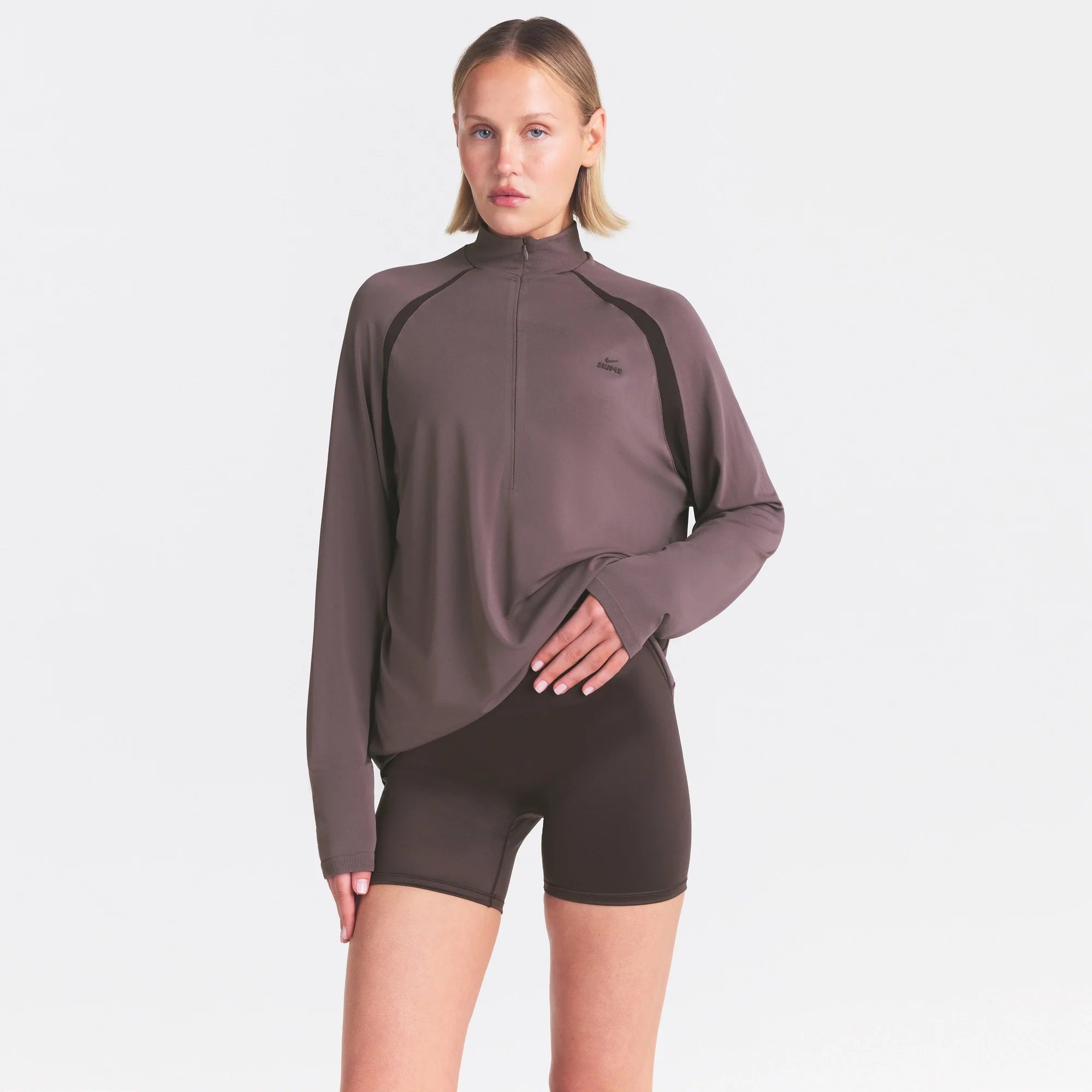 NikeSKIMS STRETCH KNIT LONG SLEEVE HALF ZIP | RESIN ON A MODEL SIDE VIEW @ | FOCUS: 0.0, 1.0, 0.9