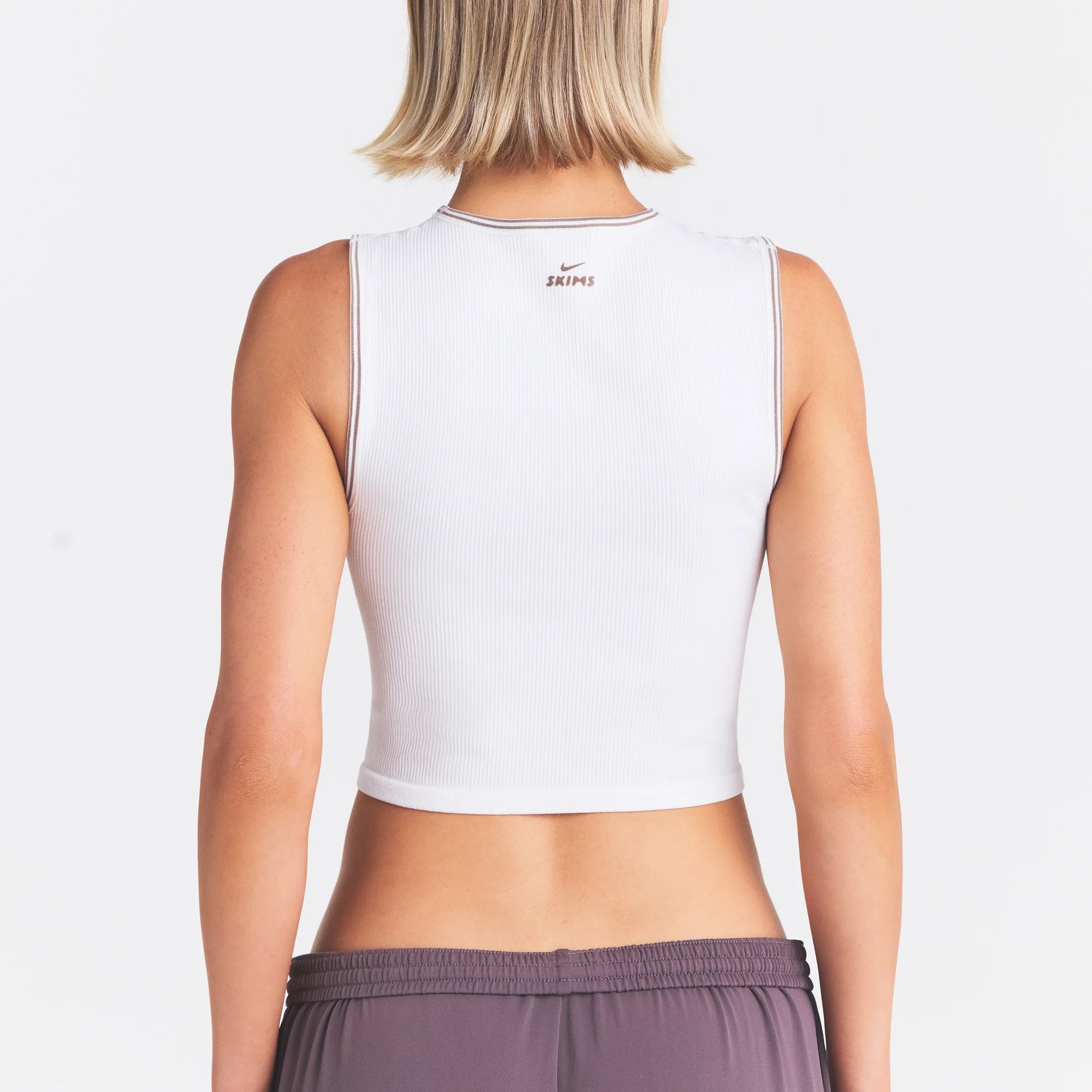 NikeSKIMS RIBBED SEAMLESS MUSCLE TANK | IVORY ON A MODEL SIDE VIEW @ | FOCUS: 0.0, 1.0, 0.9