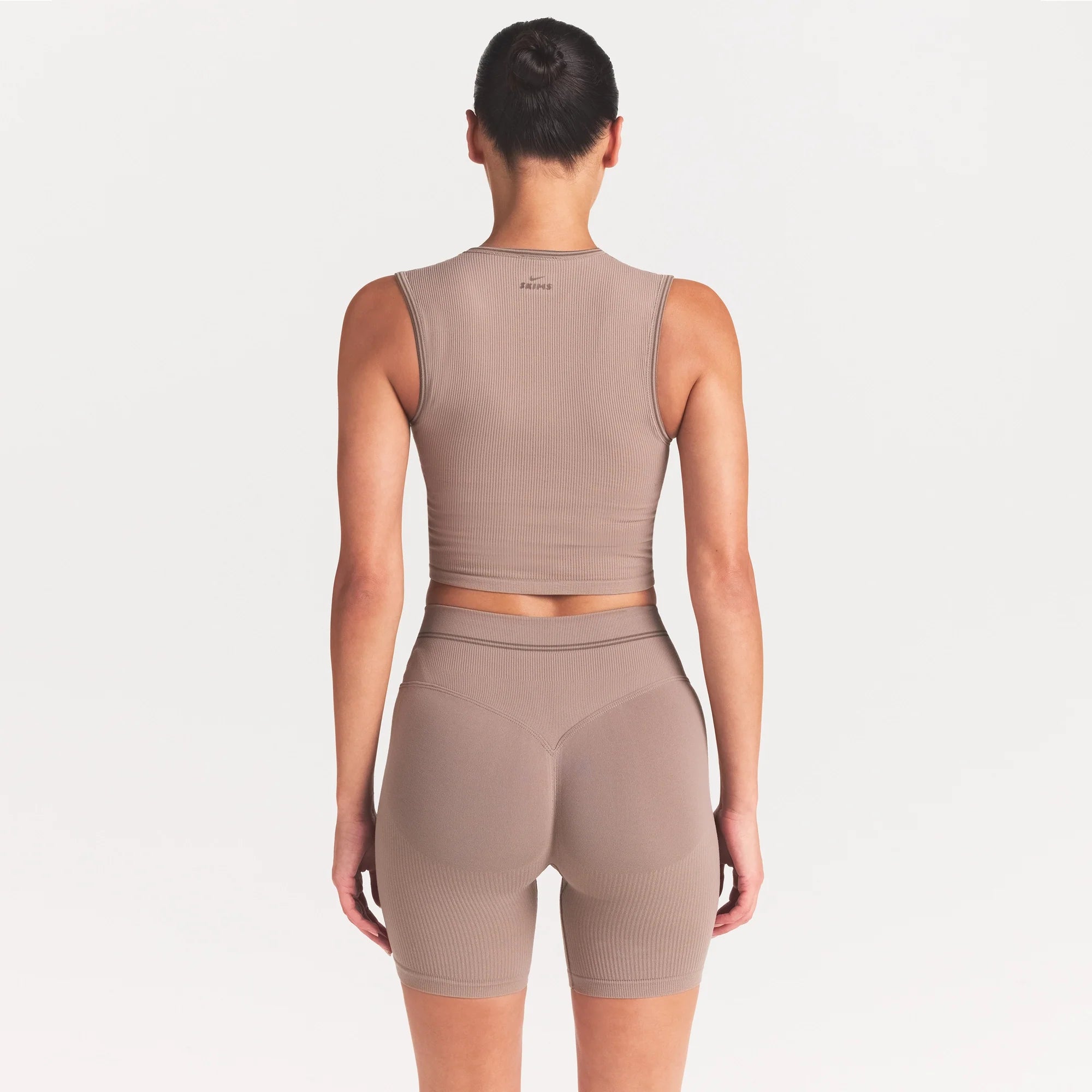 NikeSKIMS RIBBED SEAMLESS MUSCLE TANK | DRIFTWOOD ON A MODEL SIDE VIEW @ | FOCUS: 0.0, 1.0, 0.9