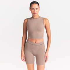 NikeSKIMS RIBBED SEAMLESS MUSCLE TANK | DRIFTWOOD ON A MODEL SIDE VIEW @ | FOCUS: 0.0, 1.0, 0.9