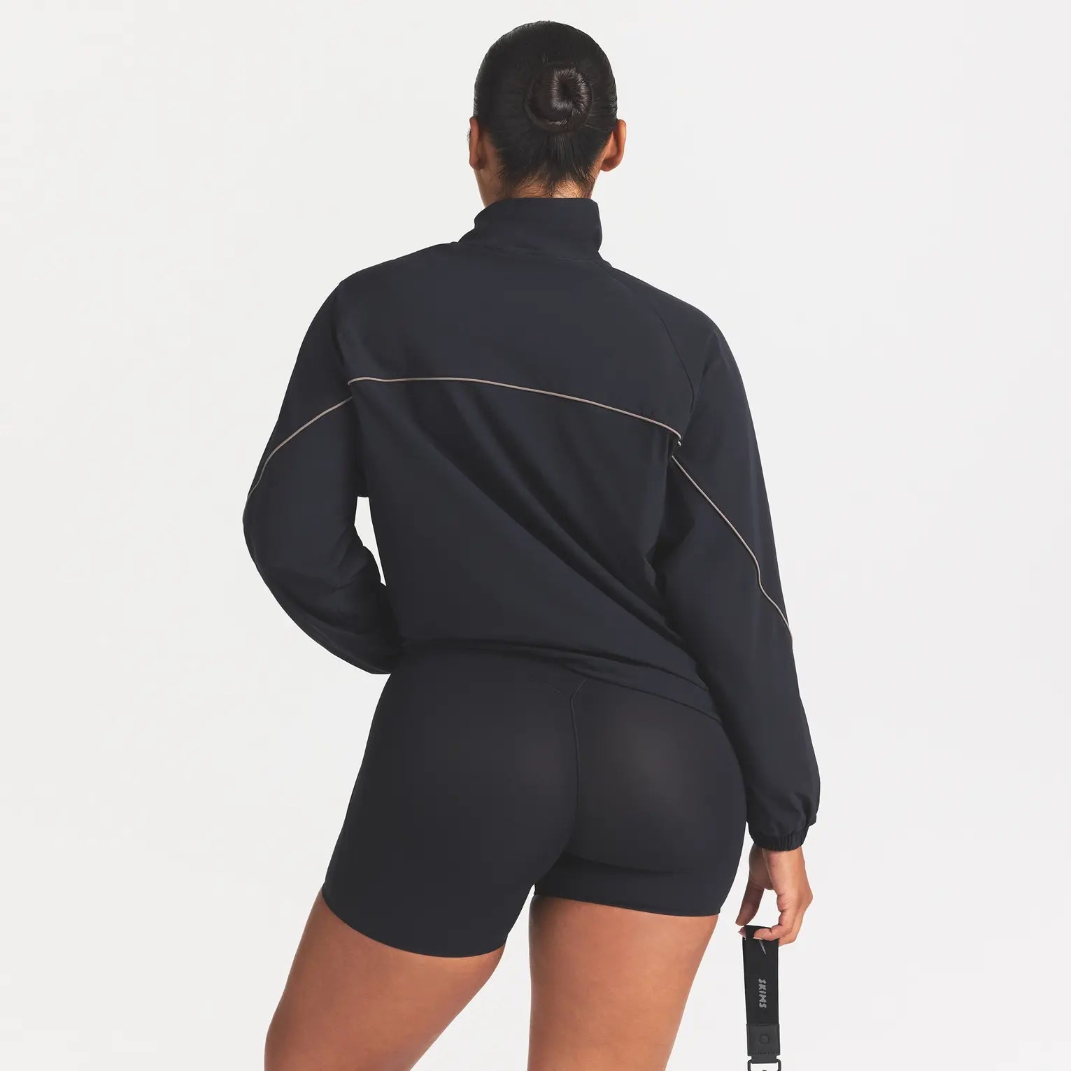 NikeSKIMS STRETCH NYLON OVERSIZED TRACK JACKET | OBSIDIAN ON A MODEL FRONT VIEW @ | FOCUS: 0.0, 1.0, 0.9