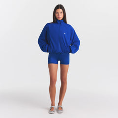 NikeSKIMS STRETCH NYLON OVERSIZED JACKET | COBALT ON A MODEL FRONT VIEW @ | FOCUS: 0.0, 1.0, 0.9