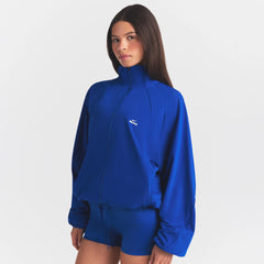 NikeSKIMS STRETCH NYLON OVERSIZED JACKET | COBALT ON A MODEL SIDE VIEW @ | FOCUS: 0.0, 1.0, 0.9
