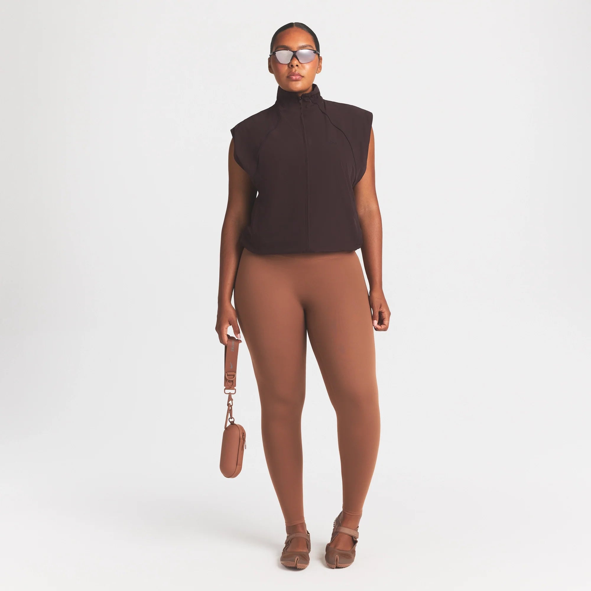 NikeSKIMS STRETCH NYLON OVERSIZED VEST | DARK ROAST ON A MODEL SIDE VIEW @ | FOCUS: 0.0, 1.0, 0.9