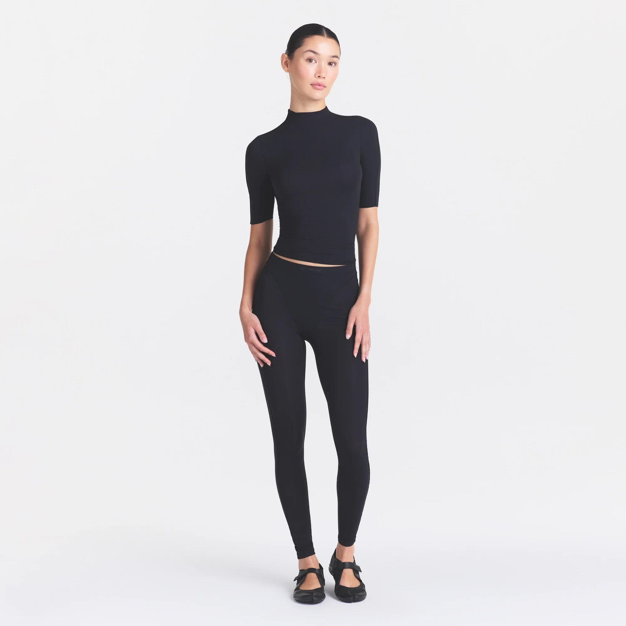 NikeSKIMS WEIGHTLESS LAYERS MOCK NECK SHORT SLEEVE T-SHIRT | OBSIDIAN ON A MODEL FRONT VIEW @ | FOCUS: 0.0, 1.0, 0.9