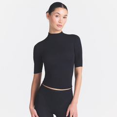 NikeSKIMS WEIGHTLESS LAYERS MOCK NECK SHORT SLEEVE T-SHIRT | OBSIDIAN ON A MODEL SIDE VIEW @ | FOCUS: 0.0, 1.0, 0.9