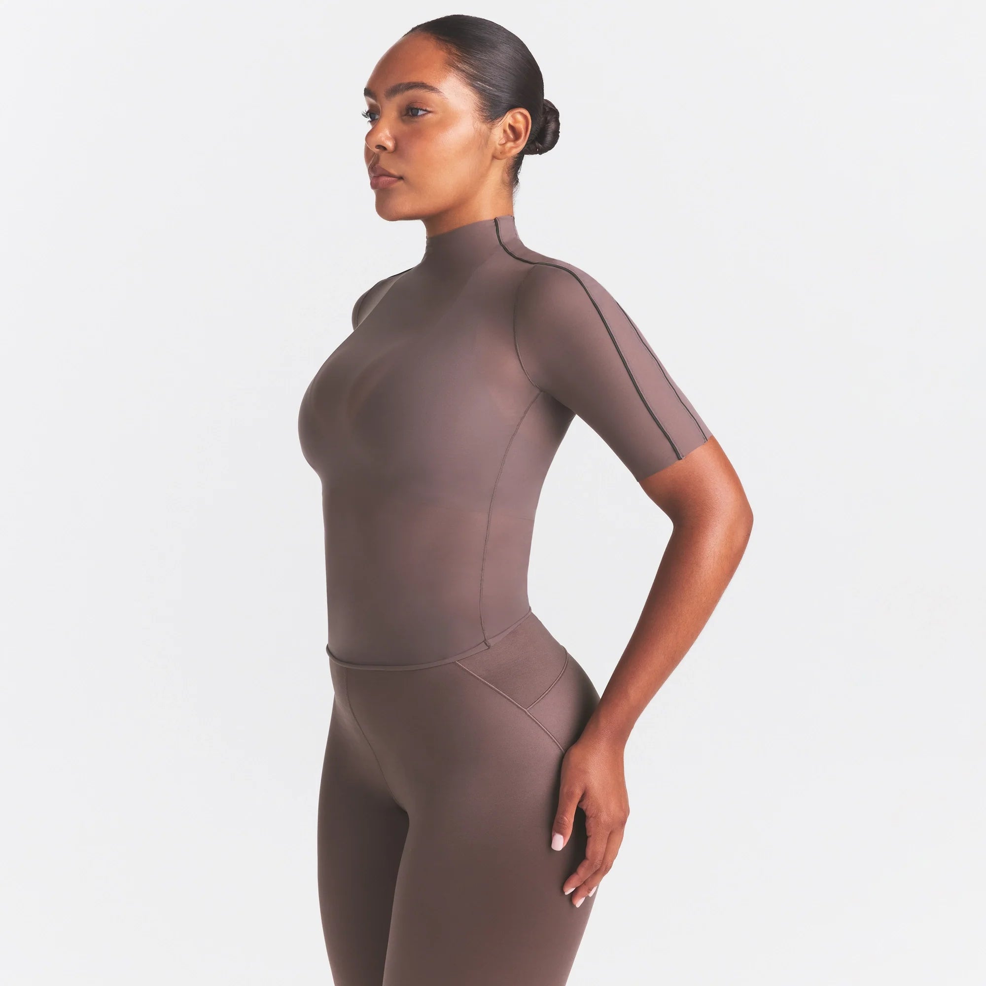 NikeSKIMS WEIGHTLESS LAYERS MOCK NECK SHORT SLEEVE T-SHIRT | RESIN ON A MODEL SIDE VIEW @ | FOCUS: 0.0, 1.0, 0.9