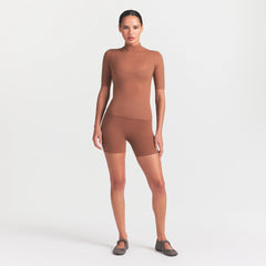 NikeSKIMS WEIGHTLESS LAYERS MOCK NECK SHORT SLEEVE T-SHIRT | CAROB BROWN ON A MODEL FRONT VIEW @ | FOCUS: 0.0, 1.0, 0.9