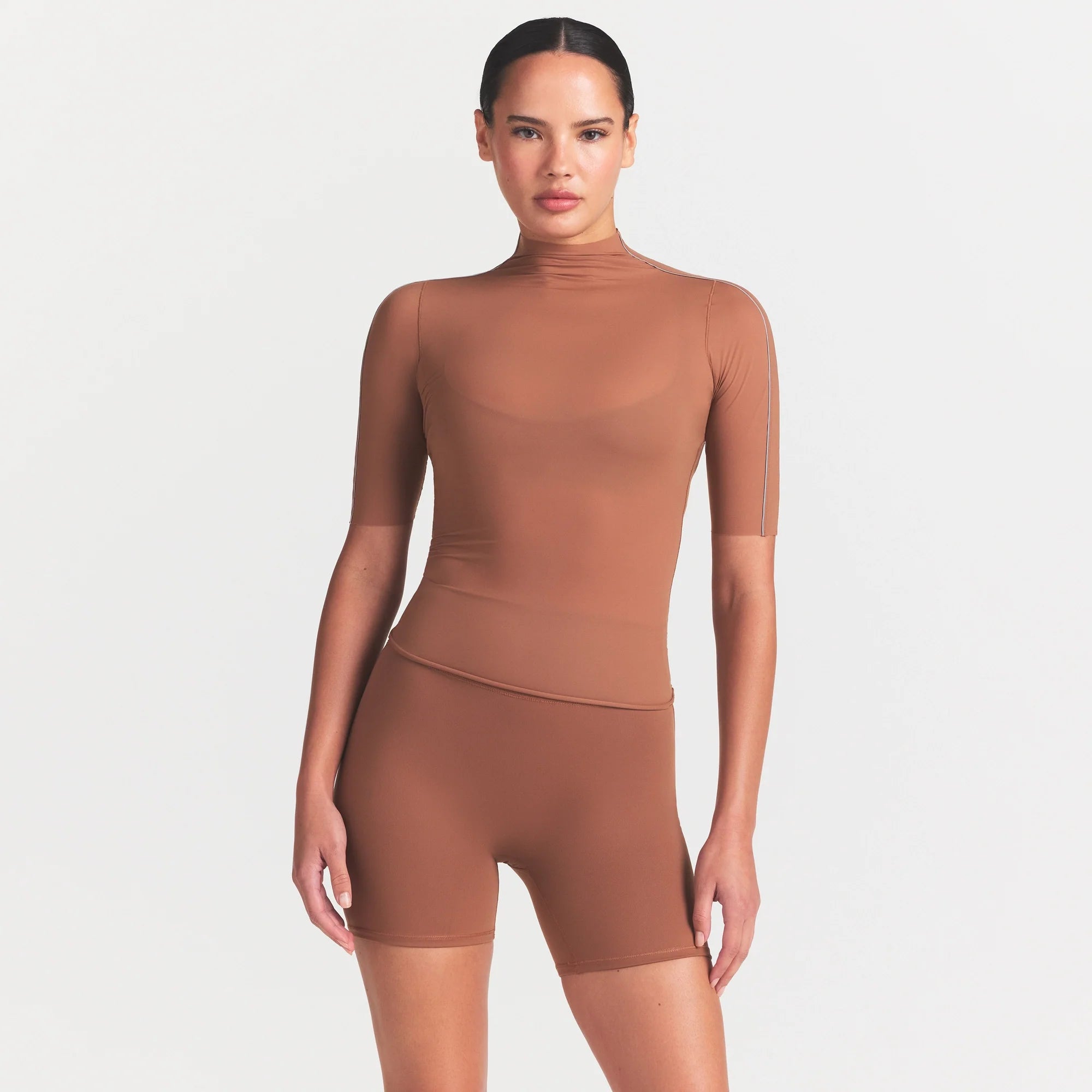 NikeSKIMS WEIGHTLESS LAYERS MOCK NECK SHORT SLEEVE T-SHIRT | CAROB BROWN ON A MODEL FRONT VIEW @ | FOCUS: 0.0, 1.0, 0.9