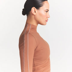 NikeSKIMS WEIGHTLESS LAYERS MOCK NECK SHORT SLEEVE T-SHIRT | CAROB BROWN ON A MODEL SIDE VIEW @ | FOCUS: 0.0, 1.0, 0.9