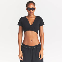 NikeSKIMS PERFORMANCE COTTON BLEND SHORT SLEEVE V-NECK TOP | OBSIDIAN ON A MODEL SIDE VIEW @ | FOCUS: 0.0, 1.0, 0.9