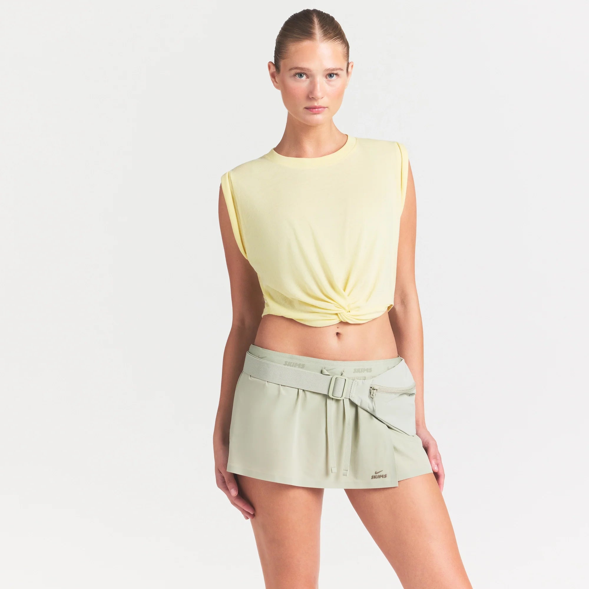 NikeSKIMS PERFORMANCE COTTON BLEND CROP TWIST TANK | BICYCLE YELLOW ON A MODEL SIDE VIEW @ | FOCUS: 0.0, 1.0, 0.9