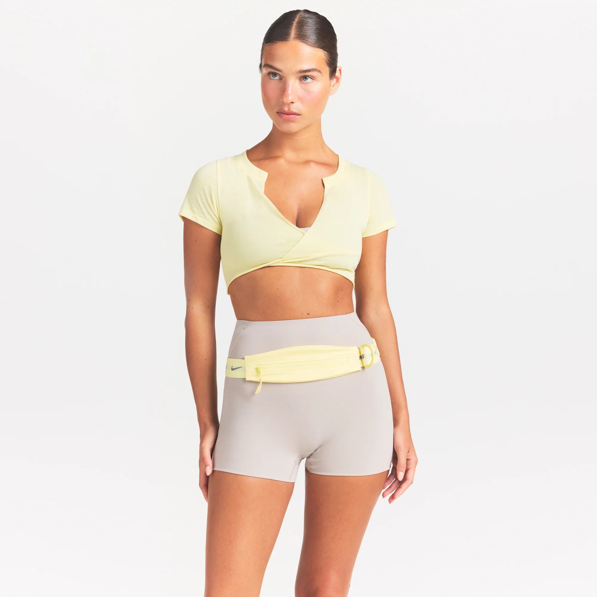 NikeSKIMS PERFORMANCE COTTON BLEND SHORT SLEEVE V-NECK TOP | BICYCLE YELLOW ON A MODEL SIDE VIEW @ | FOCUS: 0.0, 1.0, 0.9
