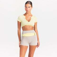NikeSKIMS PERFORMANCE COTTON BLEND SHORT SLEEVE V-NECK TOP | BICYCLE YELLOW ON A MODEL SIDE VIEW @ | FOCUS: 0.0, 1.0, 0.9