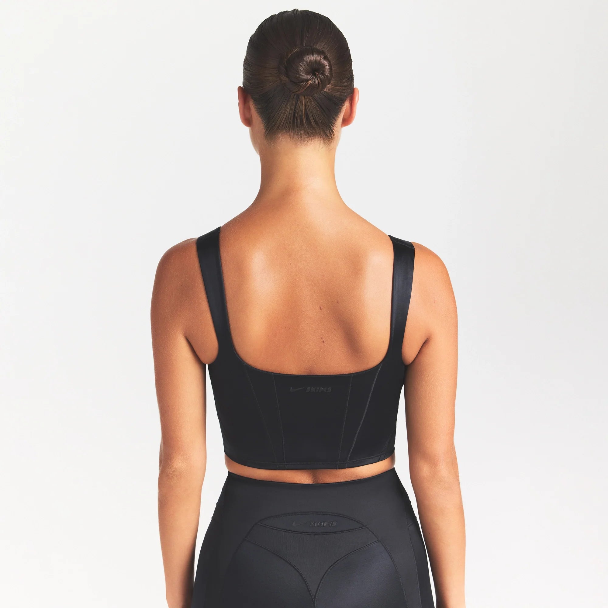 NikeSKIMS SATIN SHINE PANELED SCOOP TANK | OBSIDIAN ON A MODEL SIDE VIEW @ | FOCUS: 0.0, 1.0, 0.9