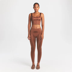 NikeSKIMS SATIN SHINE PANELED SCOOP TANK | CAROB BROWN ON A MODEL FRONT VIEW @ | FOCUS: 0.0, 1.0, 0.9