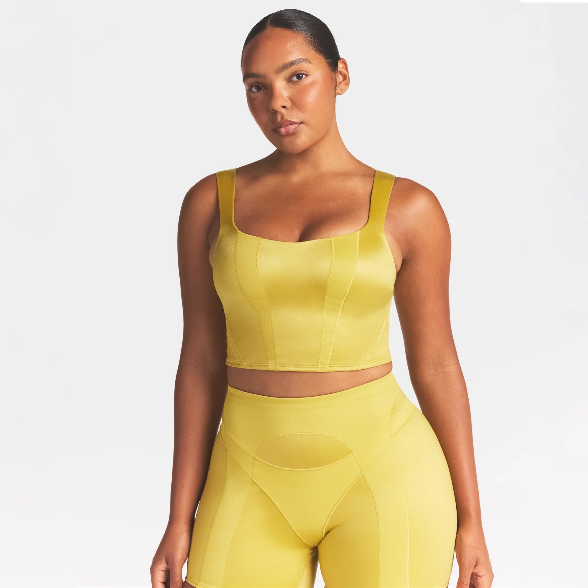 NikeSKIMS SATIN SHINE PANELED SCOOP TANK | CITRINE ON A MODEL SIDE VIEW @ | FOCUS: 0.0, 1.0, 0.9