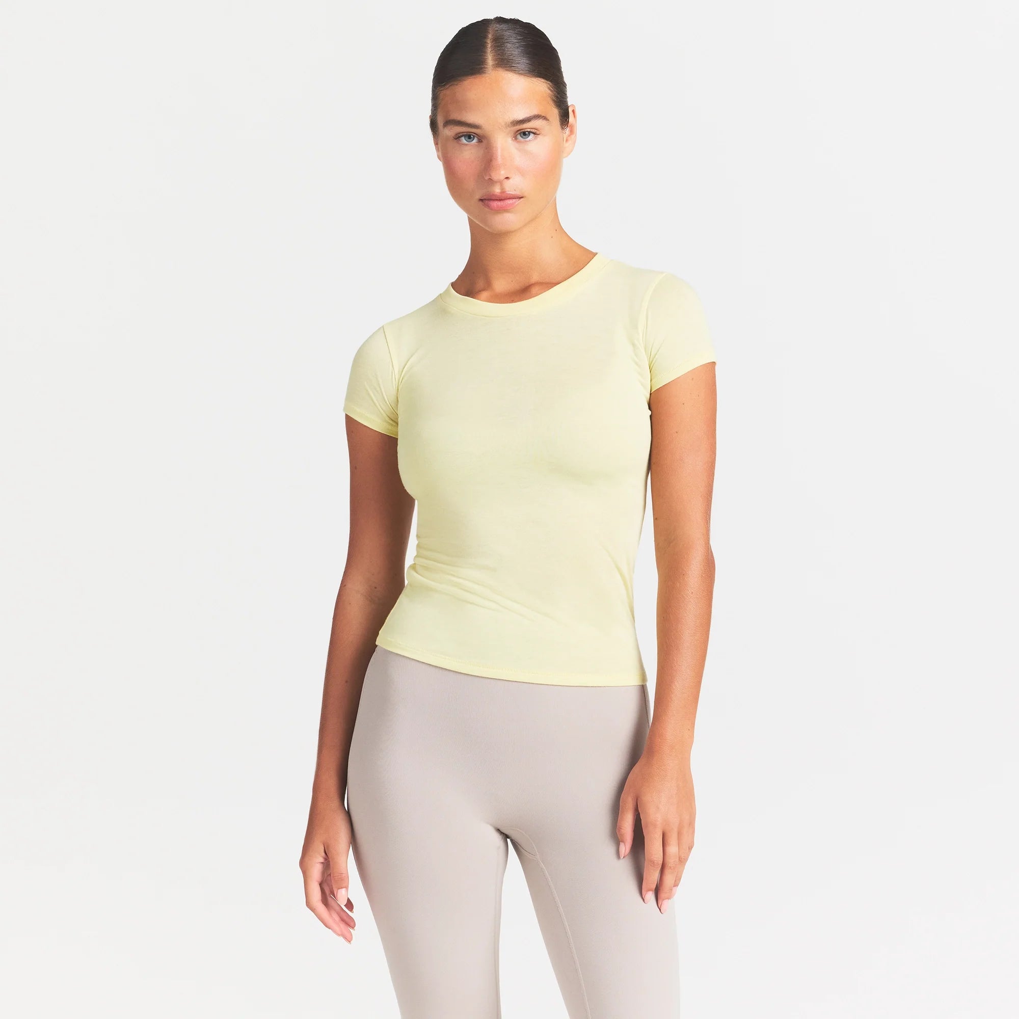 NikeSKIMS PERFORMANCE COTTON BLEND SHORT SLEEVE TOP | BICYCLE YELLOW ON A MODEL SIDE VIEW @ | FOCUS: 0.0, 1.0, 0.9